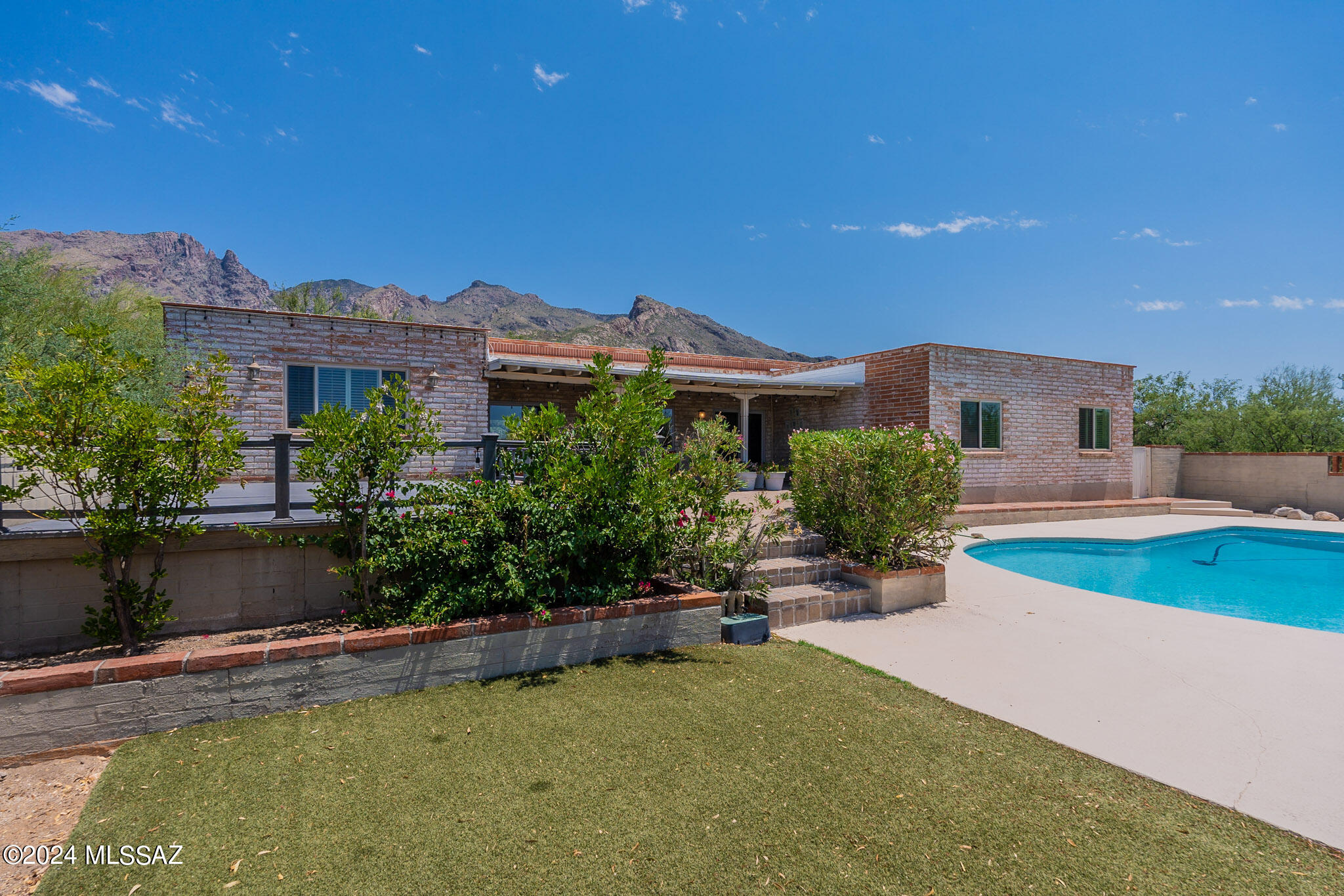 Welcome to your new home in Coronado Foothills Estates! This burnt adobe property boasts spectacular mountain views & offers 2,418 square feet of living space on a 0.73-acre lot. Enjoy the tranquility of your landscaped courtyard with mature vegetation, or take a dip in the pool. Inside, you'll find 5 bedrooms & 2 ½ baths. The living room features a cozy fireplace & ceramic tile floors, perfect for relaxing evenings. The bright, open kitchen with tile countertops, double sink, barstool seating, and ceramic tile flooring opens to the family room. The separate dining room provides access to the back porch, where you can enjoy your morning coffee or evening meals. Additional amenities include a large primary bedroom with backyard access, a patio, and covered porch off the pool. Welcome Home!