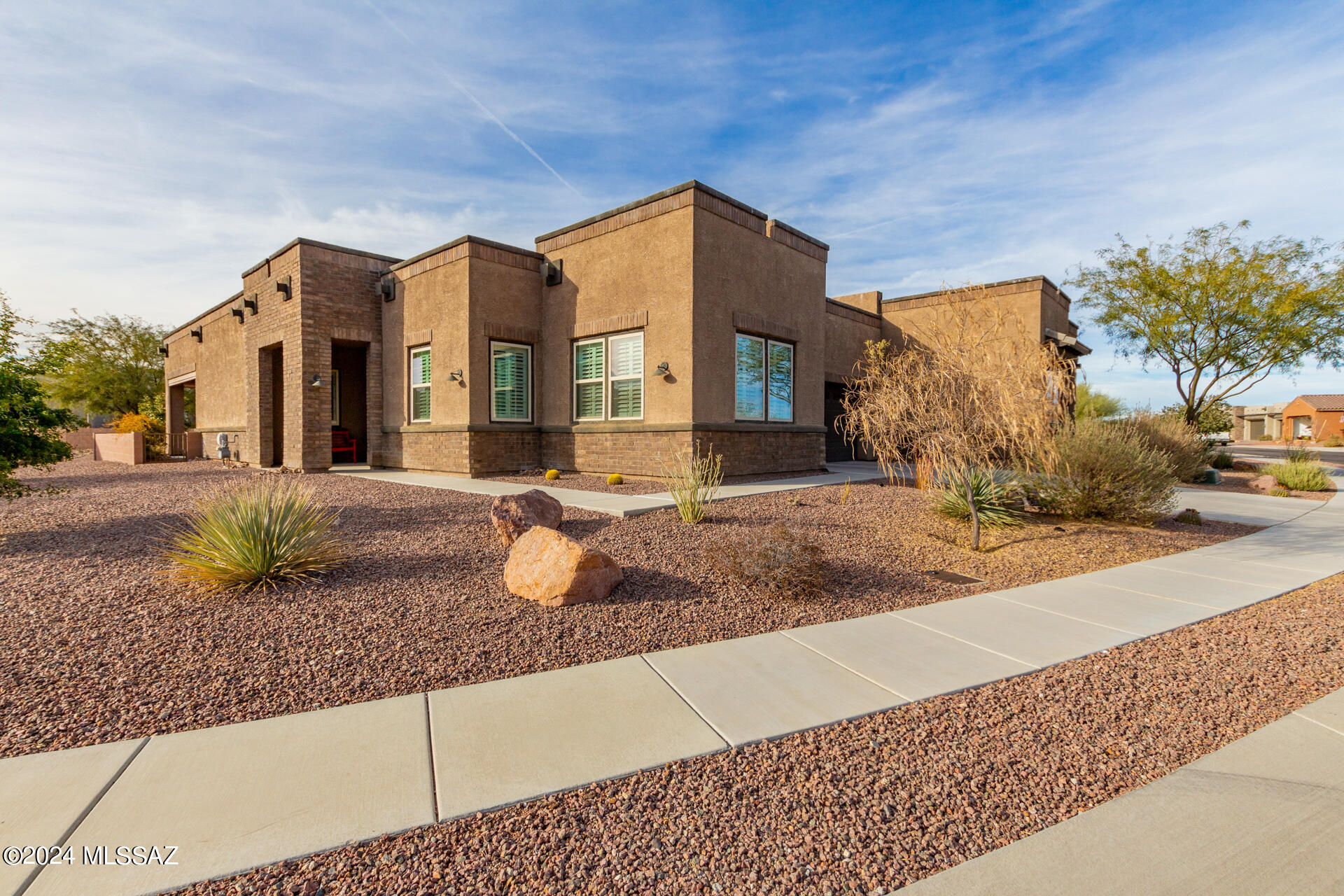 HUGE PRICE REDUCTION ~ MOTIVATD SELLER welcomes you to this luxury townhome in the highly desirable gated community of Ridgeview at Vistoso Trails. This beautiful end unit in one of the very few duplexes in the community has been highly upgraded and boasts 2113 Sq ft. Upon entry, owner's attention to detail is on full display with a custom rock feature wall in the foyer. To the right is the double door entry to a large, well-appointed den, offering great views of the dramatic Catalina Mountain Range & hall to guest quarters & bath. To your left, opens to the Heart of the Home, with spectacular gourmet kitchen, great room & dining room, w/7x20 tile and backdrop of fully landscaped back yard. The kitchen features beautiful painted maple cabinetry in Tahoe Linen, huge island with deco doors surrounding the base, Kitchen-Aid SSappliances plus wine cooler, includes 36" SS 5-Burner gas cooktop, pendant & undercounter lighting, slab granite counters in Bianco Montanha, with custom backsplash, rollouts with additional custom drawers.  Beyond the kitchen, you will find the luxurious, large master ensuite, featuring upgraded carpet, ceiling fan, window treatments with private, spacious tiled bath.  The dual sink and extensive executive height cabinetry provides tremendous area for storage and getting ready for your day/night.  Custom walk-in tiled shower with glass doors, private water closet, linen closet & walk-in closet featuring California Closet's design.  Your outdoor living space provides a private sanctuary for outdoor living and boasts 2 very large rolling sunscreens for privacy & shade.  The professionally landscaped back yard is low maintenance with drip system.  The large 2-car garage also has California Closet Storage Units for organizing all the extras. As you enter the home from the garage, you will find a delightful "drop zone" with slab granite and matching cabinetry.  Just to the right is the laundry room with matching cabinetry, built in sink and Whirlpool washer and dryer.  This luxury townhome can be purchased furnished ~ with the  
 exception of a few personal pieces, linens, dishes and flatware. Majority of furniture was custom designed and purchased from Thomasville for this lovely home.  Please ask listing agent for list.  Safe in home conveys