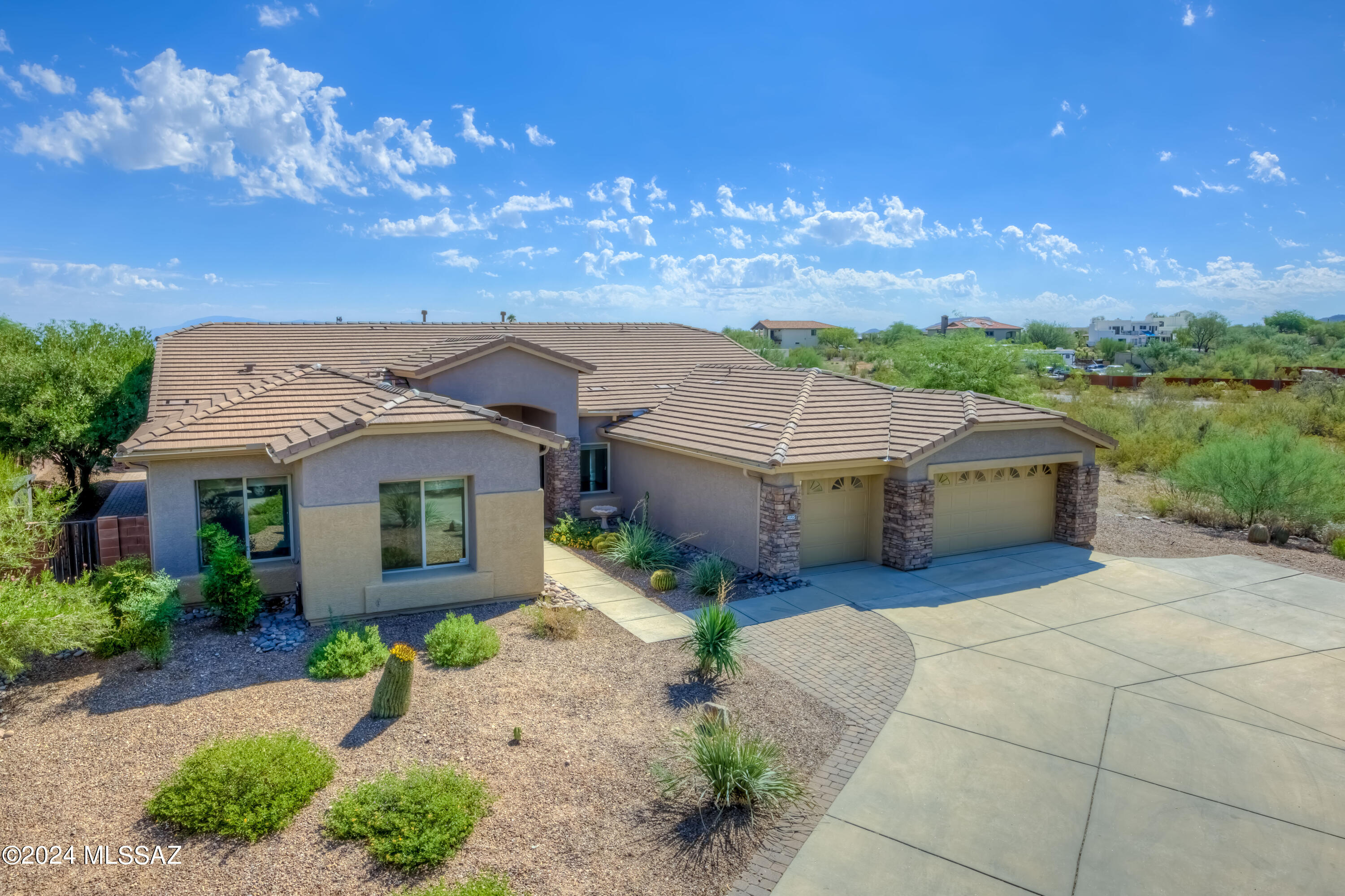Tucked away in a secure gated community on a peaceful cul-de-sac, this 1.25-acre lot offers serene living with over 3,200 sq. ft. of open-concept design. Recent upgrades include one NEW HVAC as of 6/26/25 and one rebuilt with new compressor, roof underlayment & vents and full interior/exterior paint. The home is equipped with energy-efficient features, including LED retrofitted lighting, window sunscreens and a variable speed pool pump . Natural desert landscape beyond the back wall allows uninterrupted mountain views. This single-story, 4-bedroom, 3-bathroom home features a split-bedroom layout for added privacy. The luxurious primary suite boasts a spa like bath with a  jetted tub, twin vanities, a large walk-in closet, new blinds and private accdess to the covered patio.  The resort-style backyard is perfect for entertaining, featuring a sparkling pool, spa, built-in gas BBQ under a ramada, gas fire pit, and outdoor shower. The low-care landscaping with drip irrigation, pavers, and turf grass was all installed in 2022. An extended 3-car garage with ample storage completes this move-in-ready home.