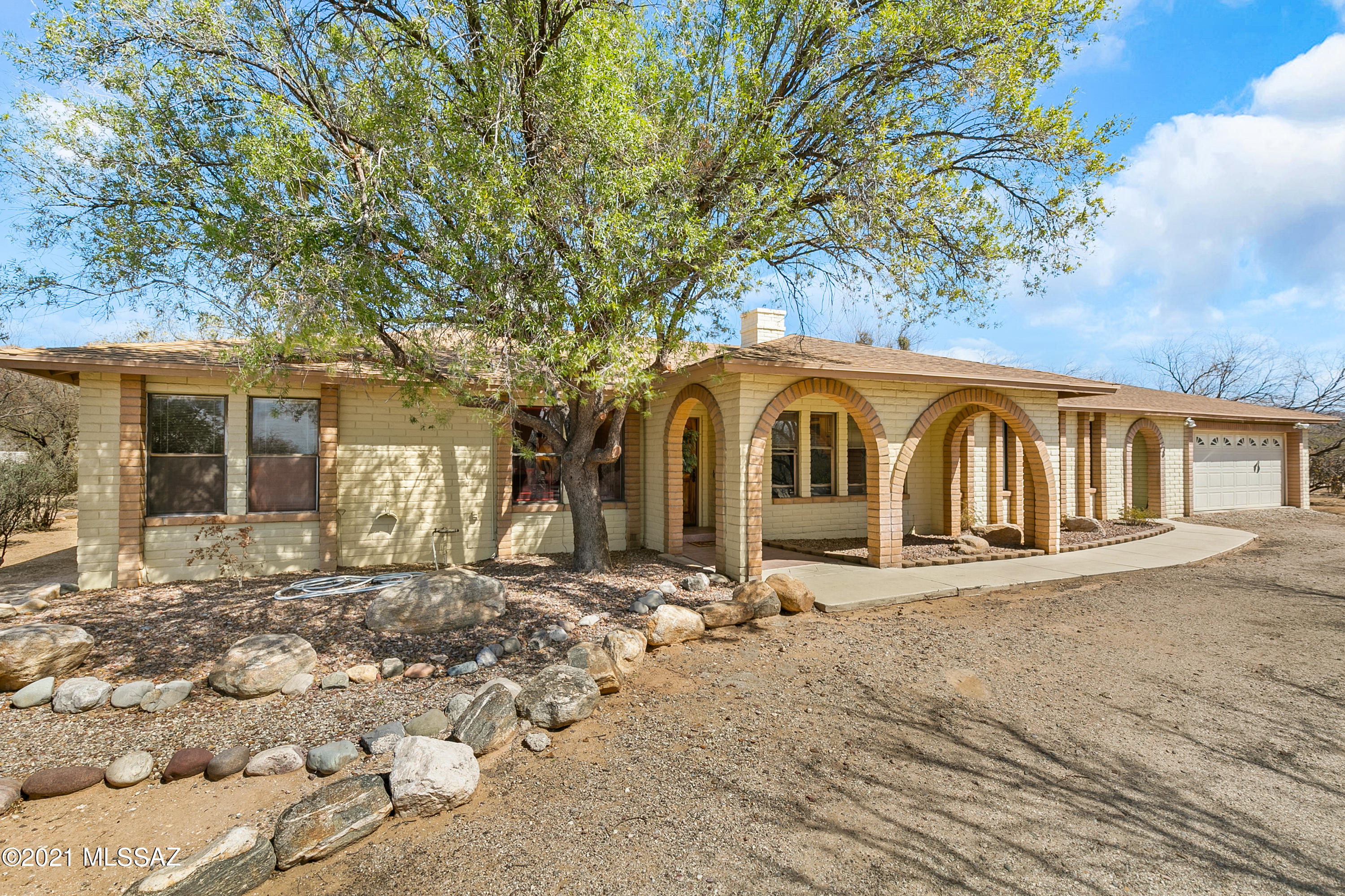 Magnificent mountain views abound from this picturesque lot on over an acre and at the end of a cul de sac. Masonry constructed and lovingly maintained home features vaulted tongue and groove wood beam ceilings, distinctive rock fireplace and split floor plan with guest quarters. Deluxe kitchen has been updated  with double oven, island cook top and tile backsplash. Fabulous outdoor living with sweeping covered patio, sparkling pool, forever views and gorgeous desert vegetation. Master suite has walk in closet, dual vanity, and jetted bathtub. Plenty of room for RV parking and all the toys. No HOA. Custom crafted built ins. This treasured home has it all.
