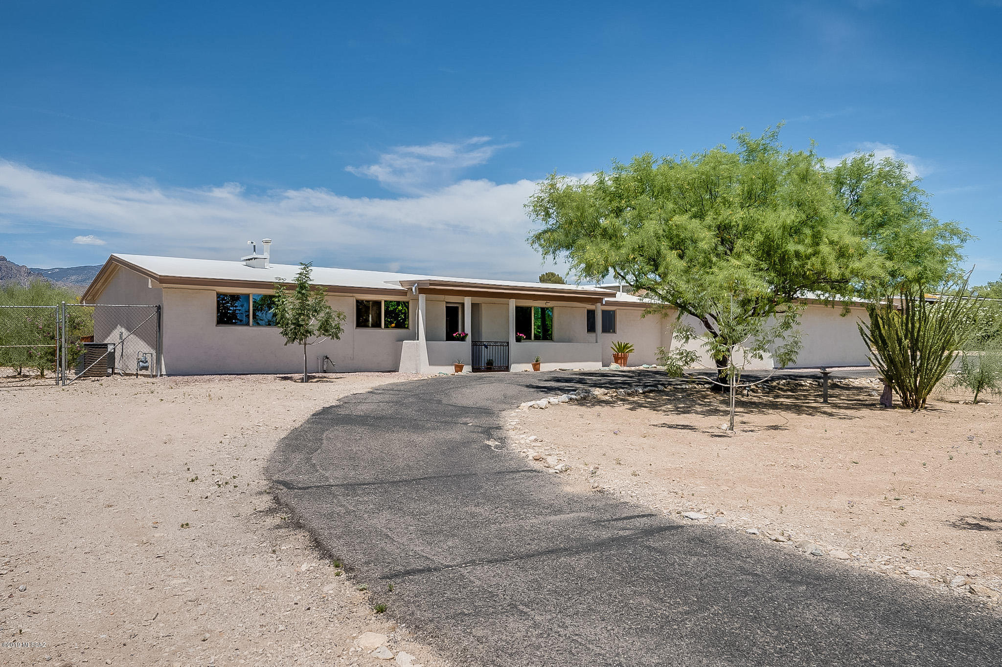 Located in the Tanque Verde Valley, this beautiful 3 bed/2 bath home on a large lot has a north facing yard with gorgeous mountain views, pool, spacious and updated kitchen with plenty of room for an island, remodeled baths, newer roof, newer dual pane windows, plantation shutters and new high efficiency AC.  Tile throughout! The 1500 sf shop (approximate cost:  $100K) is fully permitted with space for 6-8 cars (in addition to two car attached garage), is completely insulated and has evaporative cooling.  Shop also has a 10x30 mezzanine for added storage, (2) 12' doors and plenty of room to store all your toys! No HOA!