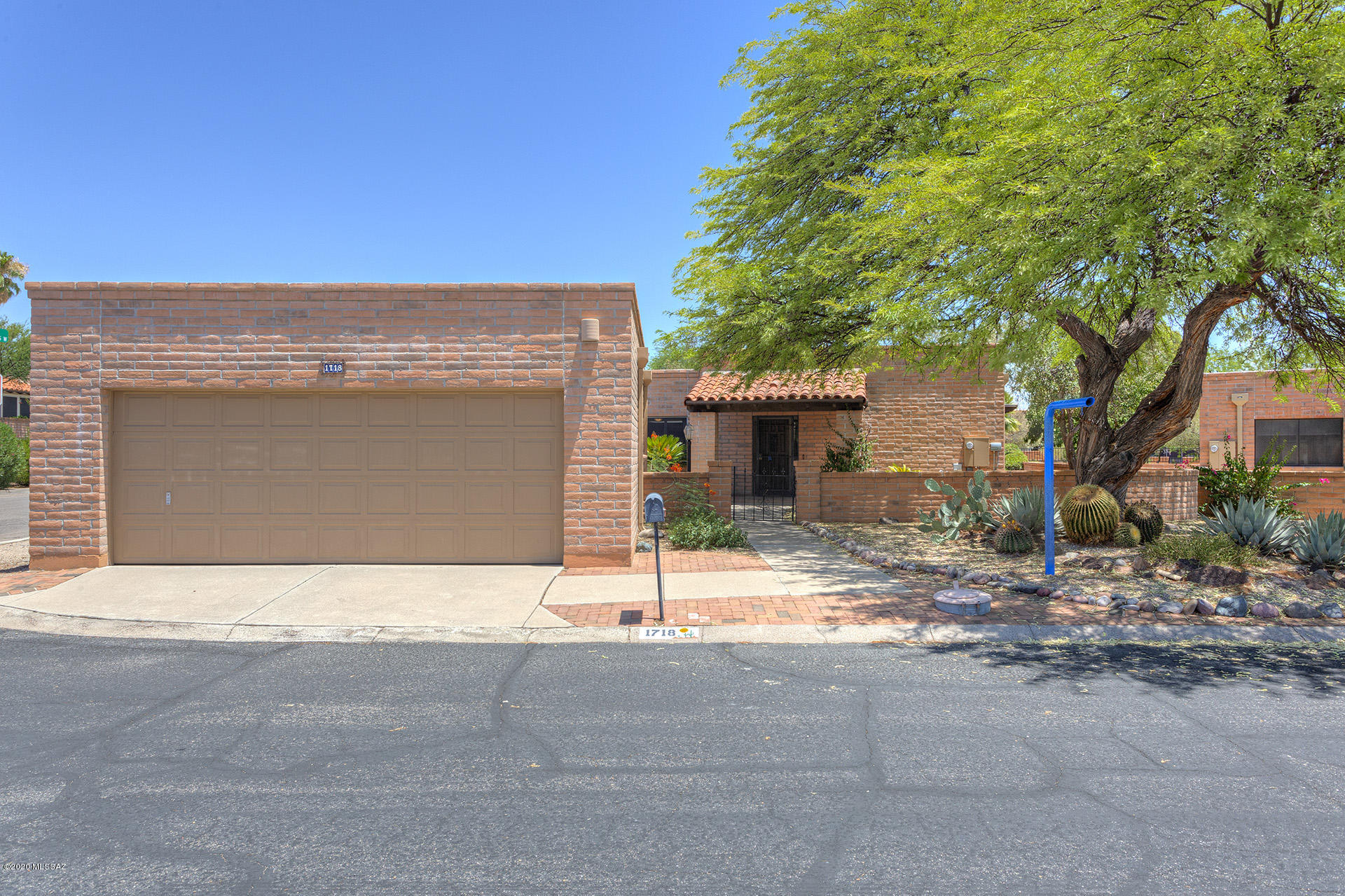 Enjoy desert views and outdoor spaces from the comfort and privacy of your wrap-around screen room, with access from both bedrooms and the living room. Located in popular Desert Hills 5, this 2-Bed, 2-bath, 2-car garage home is situated on a shady corner lot adjacent to a park-like common area; the adjacent house has no facing windows.  Smooth-sliding patio doors make it easy to come and go.  Saltillo tile and laminate flooring throughout the interior.  Full-size laundry in indoor closet.  Range and refrigerator installed since 2012.  See document section for sellers' improvements.  2-10 Home Warranty offered.
