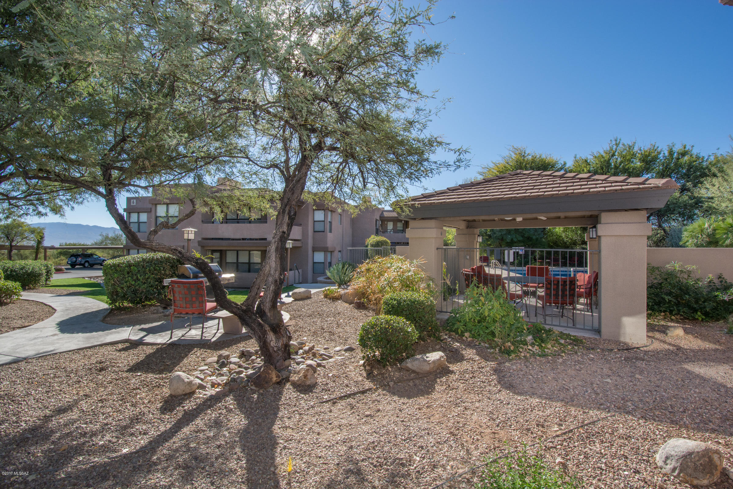 Across from Loews Ventana Golf Resort, lovingly maintained ground floor casita in the Greens, NO ONE ABOVE YOU. End unit, high ceilings, fireplace in living room, wood laminate floor in most areas. Walk-in closet in each bedroom. Patio overlooking grassy area with trees. Covered parking #223 right outside unit; guest parking across street. Pet friendly, 3 pools (2 heated), fitness center, HOA dues cover water, trash, roof, common area maintenance and landscaping. Move-in ready.