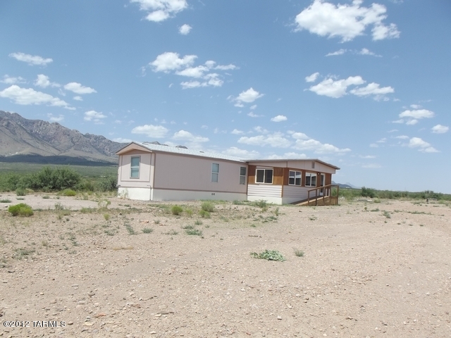 AFFIXED MANUFACTURED HOME ON 6 ACRES LARGE ENCLOSED FRONT PORCH WITH GREAT VIEWS. PUBLIC LAND TO THE SOUTH OF THE PROPERTY. STEEL BARN ON SLAB AND ANOTHER STEEL BUILDING WITH SHELVING. NEW ROOF WITH 30 YEAR SHINGLE ROOFING.