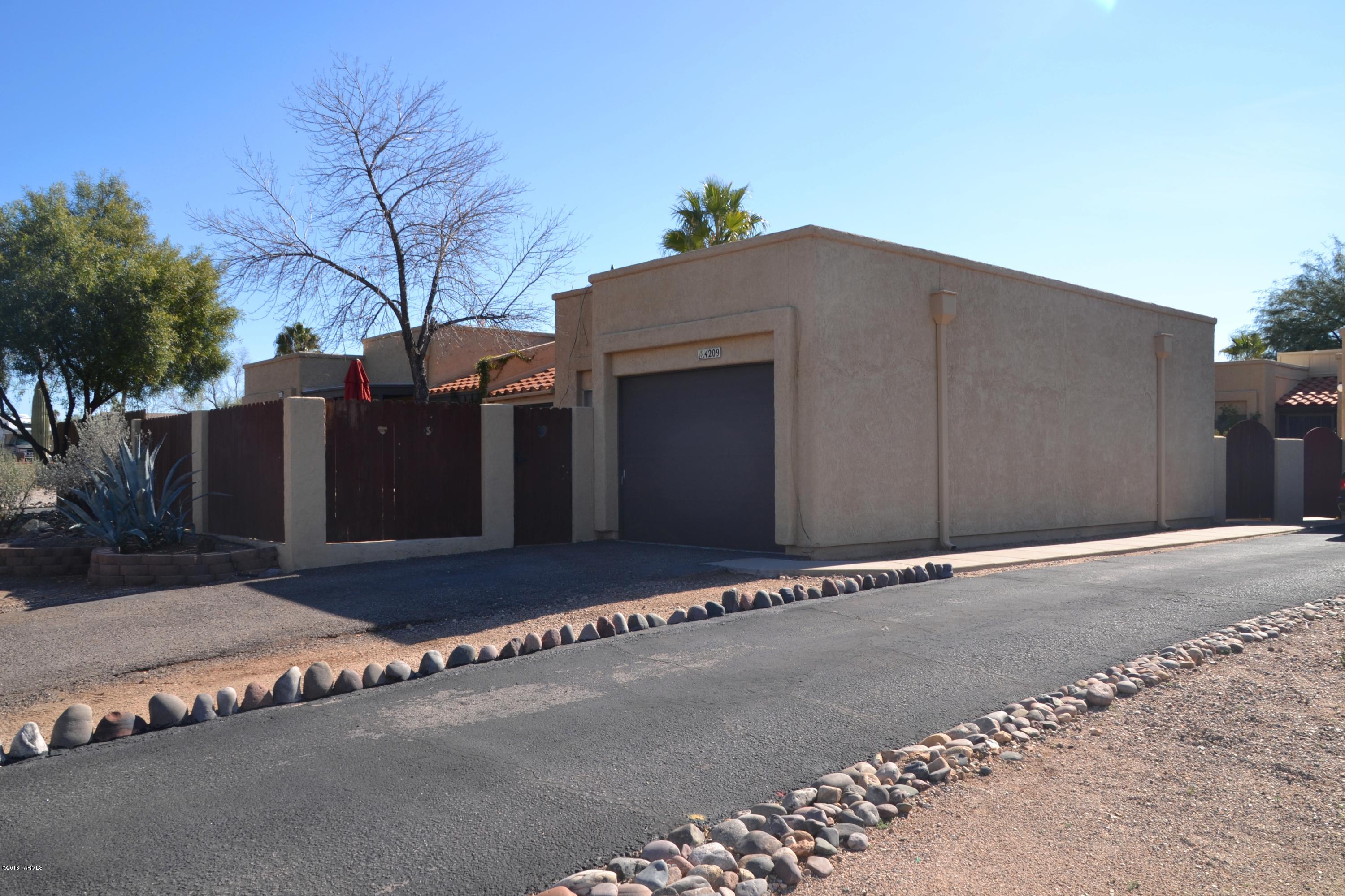 Great Northwest Area. This Wonderful 2 bedroom 2 bath Townhouse is move in ready. Upgraded kitchen with new back splash, Corian counter tops, and hardware on all cabinets.The pantry door is edged decorative glass and has newly installed shelves. Fresh paint throughout.  A fireplace to keep you warm on those Arizona chilly nights and Ceiling fans in all rooms to cool you off.Back porch enclosed and can be used for an office or den.Enjoy the morning sunshine with your own fenced in patio. This beautiful Townhouse has a one Car Garage!! Come take a look!