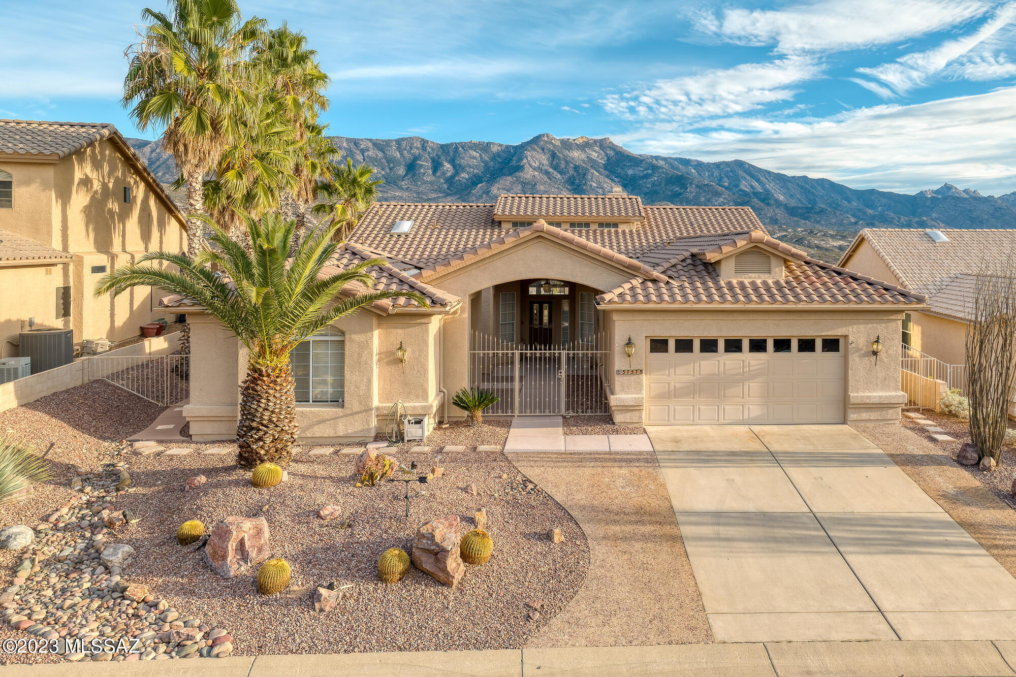 Spectacular unobstructed Mountain views. This home features the Estancia floor plan (2437 sq. ft) & private east facing backyard. Enjoy the front courtyard and separate casita giving you & your guests complete privacy. The bright open living & family room is separated by a double-sided gas fireplace. Primary bath has a soaking tub, walk-in shower, dual vanities and an ample walk-in closet. The garage with storage cabinets has been extended making it easy to park 2 cars + a golf cart. Great hobby/laundry room combo off garage.  Enjoy your Mountain Views all day from this serene private backyard with covered patio, outdoor kitchen with built-in gas BBQ & viewing patio. SaddleBrooke is Tucson's Premier Active Adult Community w/ Fitness Center, Pool, Golf, Tennis & Performing Arts Center.