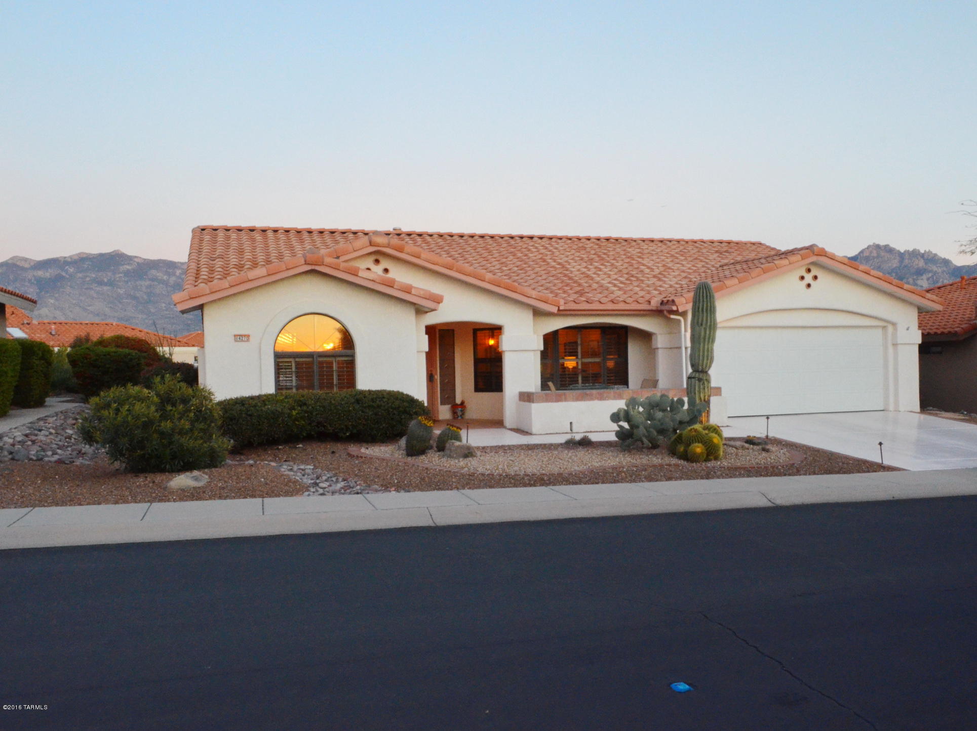 Stunning Catalina Mountain views! Enjoy Sun City Vistoso's active adult community  in a 2BD Pacifica model (1,750sqft). This Del Webb home features Saltillo tile, plantation shutters, front security screen door, fireplace, small office & built-in entertainment center. The formal dining room/living room combination is a great space for entertaining family and friends. This desirable floor plan includes split bedrooms with 2 full baths. The master bath includes two sinks, large soaking tub, shower, & walk in closet. There is no shortage of storage in the 2 car garage with additional golf cart space. Enjoy fabulous outdoor entertaining w/extended patios, professional landscaping, waterfall & magnificent mountain & sunset views. This home is ready for new owners!