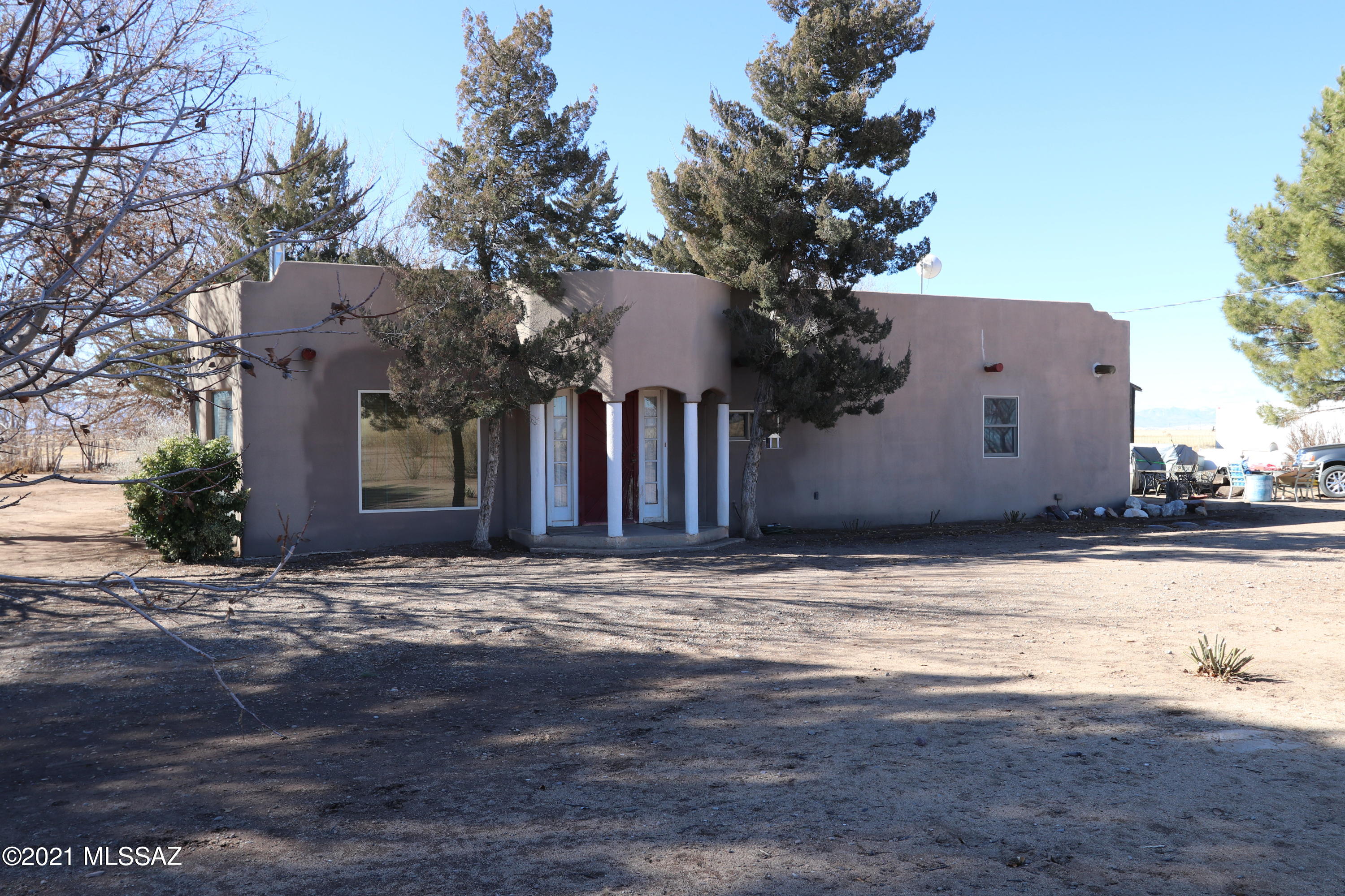 Santa Fe style house on 30 + acres located in Cochise County,  SE Arizona. 3 Bed rooms 2 baths. Large family room. Walk in Pantry. New stainless steel appliances in Island kitchen. large Laundry room. Ceiling fans. Wood burning stove. Sky lights. New Anderson windows and door. New deep well in new well building with 2 large pressure tanks. Large workshop/garage. Plenty of shade and fruit trees. Fully fenced 30 + acres. Surrounded by majestic mountains including national forests. Hike, Bike, camp and hunt. Farming and ranching area. American Viticulture area (AVA). Nearby vineyards, wineries and tasting rooms.  Nearby cities and towns include Willcox, Benson, Sierra Vista and Tucson.