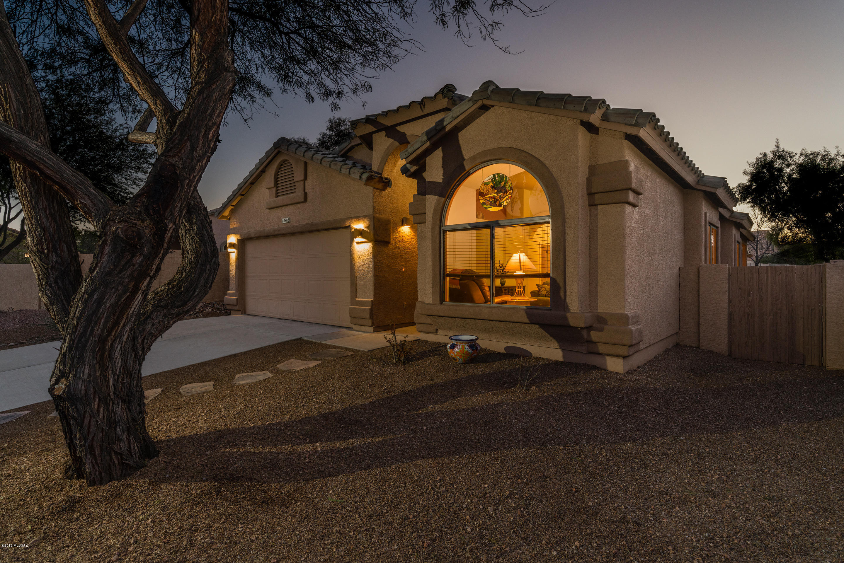 Beautiful, immaculately maintained home in Rancho Sahuarita! Home boasts soothing interior palette, soaring ceilings, and gorgeous ceramic tile! Open kitchen features island with breakfast bar, oak cabinetry, LG High Macs countertops and white appliances. Huge great room is perfect for entertaining or relaxing with family in front of the fireplace!. Spacious master suite is the ultimate place to relax and unwind. Two more spacious bedrooms. Landscaped backyard with covered patio is the perfect place to enjoy the Arizona sunshine. Make this your home today!