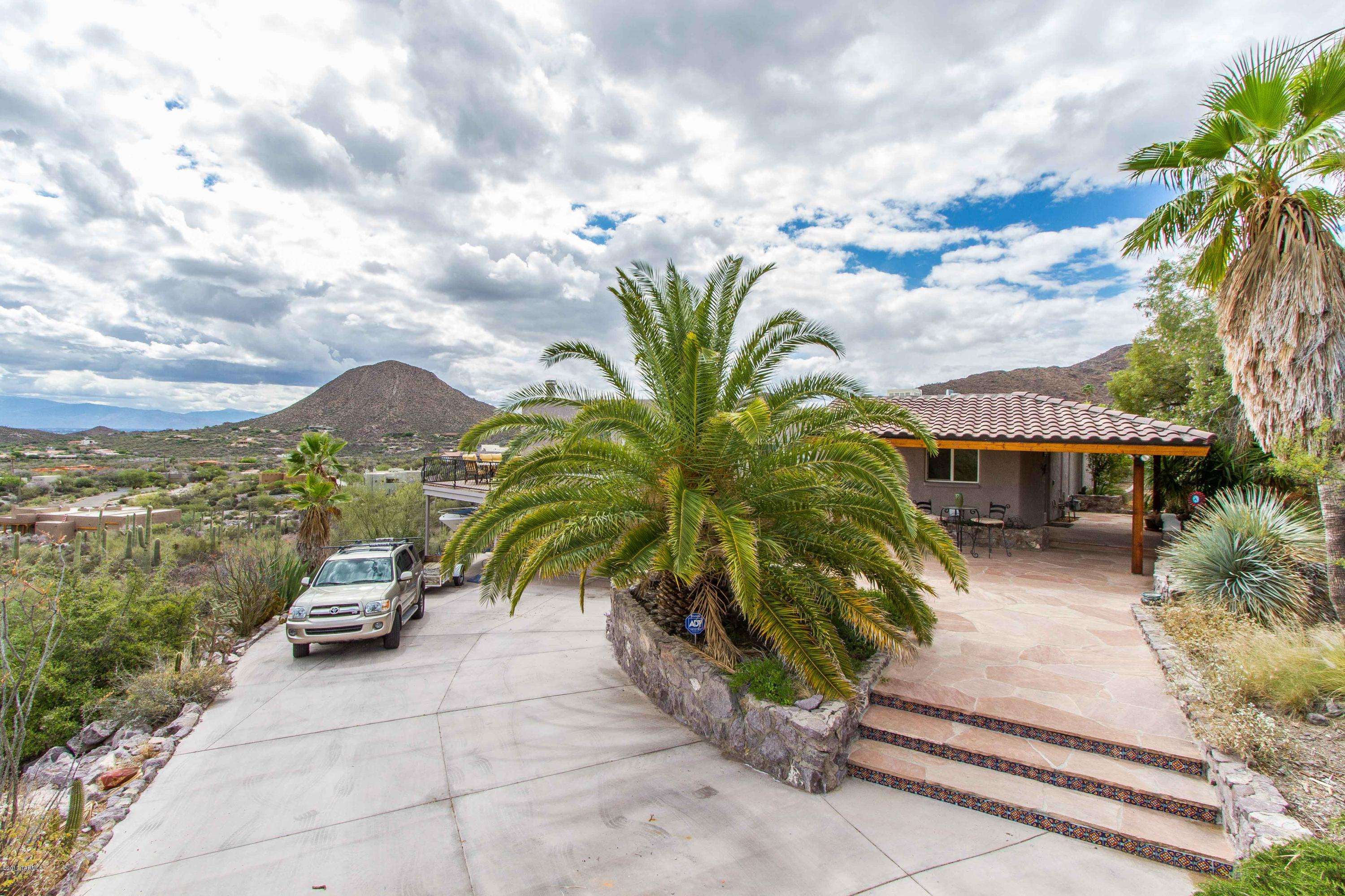 Amazing opportunity to own this beautiful West side home with INCREDIBLE VIEWS and outdoor living space! Private lot with multiple deck areas, endless pool, mature landscaping and spacious driveway. Large windows help bring the beautiful in! The home also features updated kitchen with stainless steel appliances and granite counter tops, updated bathrooms, large great room with fireplace,  and an over-sized master suite with bonus space that could be used as an exercise room, office or sitting area.  Easy access to I-10, downtown, U of A, entertainment, shopping and amenities. This is a must-see!