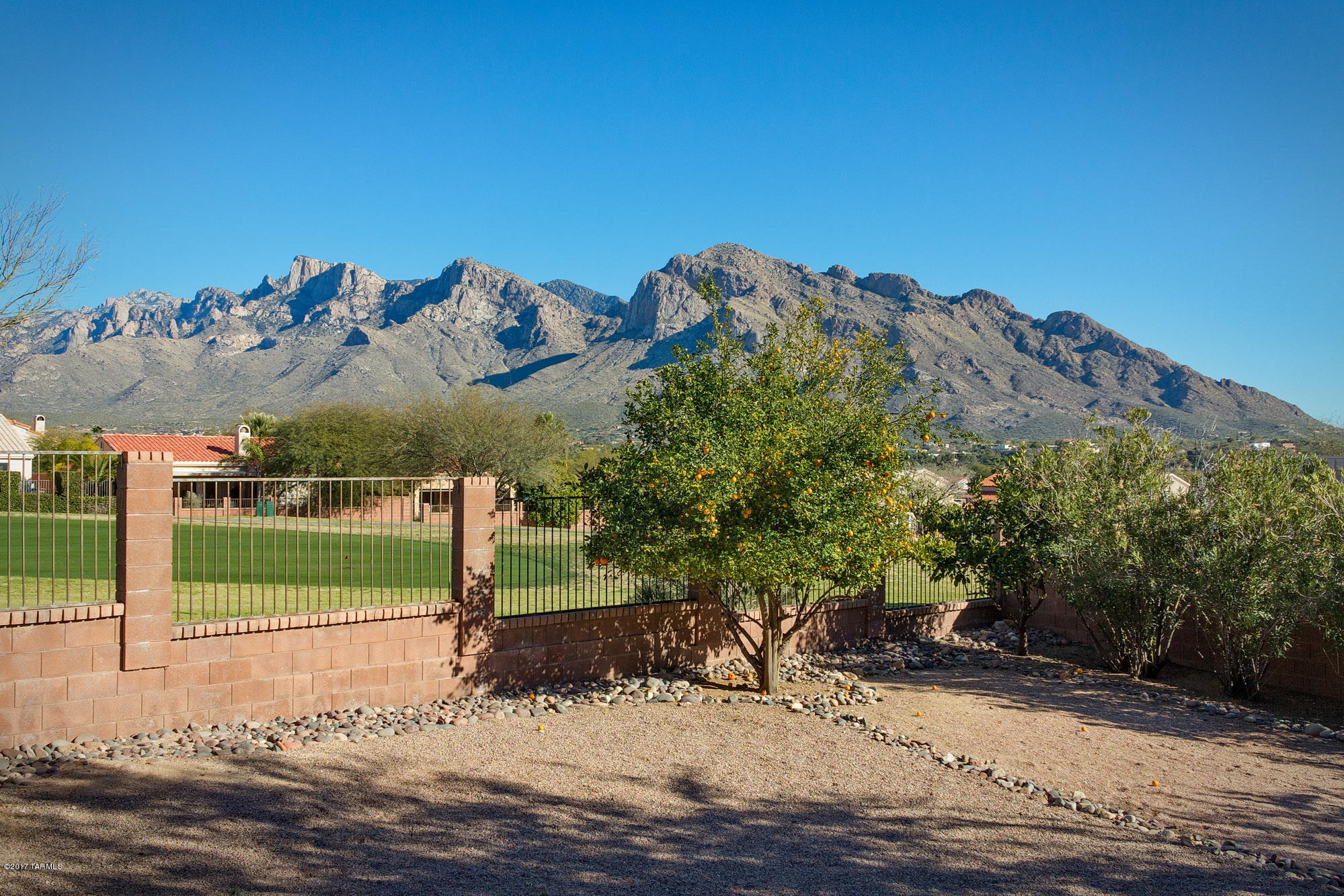 Impeccable Catalina Mountain and Golf Course Views are yours to enjoy! The dramatic entryway w/ soaring ceilings compliment this light & bright open concept. Spacious 5 bedroom and 3 bath home in the gated Villages of La Canada Oro Valley Community. The kitchen has an abundance of cabinetry, new stainless appliances, breakfast bar and pantry.The family room has a cozy fireplace and picture windows showcasing the sweeping mountain views. One bedroom and full bath downstairs. This home is situated on a double, cul-de-sac lot for additional space and privacy. Enjoy the backyard basketball court and pool-sized backyard. New interior and exterior paint. No Poly Pipes. Completely move-in ready!