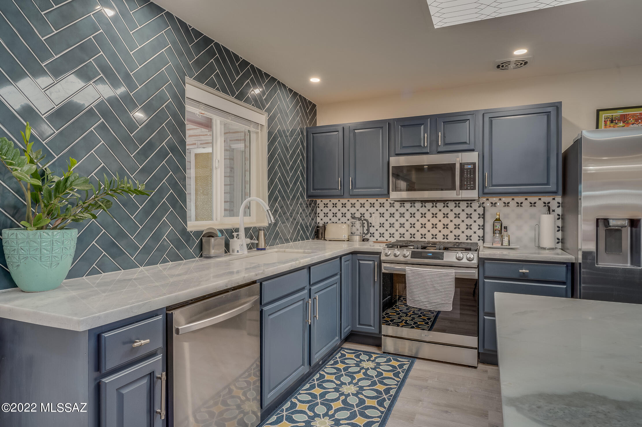 **UPDATE** Seller is aware that high interest rates are affecting what buyers can afford so she is willing to pay up to 1% of the loan amount towards a permanent buy down interest rate!! That means a lower rate for you! Check with your lender, you can afford this Mid Century Modern lovers dream come true! This tastefully renovated home will win you over the moment you enter. All of the upgrades were well thought out and done with care. Huge kitchen opens up to the living and dining room, creating a nice open feel. Plenty of room for your family inside, and a large yard with pool and mountain views that's perfect for entertaining. Bonus Room with bathroom could be used as a bedroom, den, or office. To complete this perfect home, there's not 1, but 2 stunning wood burning fireplaces. Please reference upgrades list for complete list of upgrades and renovations. This home is not a flip, and is truly a special home located right in the heart of Tucson in the Mitman Addition subdivision