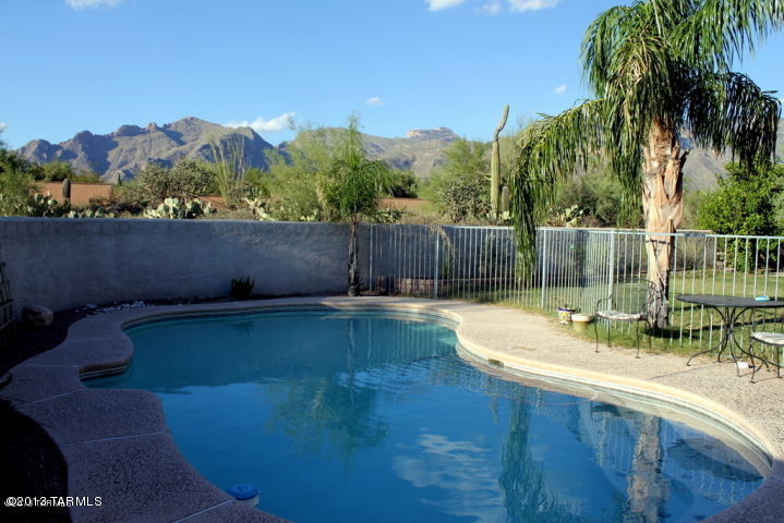 This beautiful 4BD/2BA home is located at the end of the cul-de-sac and has magnificent mountain views.  Located in District 16.  Spacious home with lots of light, soaring ceilings, remodeled kitchen with beautiful granite countertops, fireplace in family room and huge windows in great room to look out at the Catalina mountains.  Fenced pool, grassy lawn and beyond the yard is where you'll find varieties of cacti, birds and wildlife.  Won't last long!