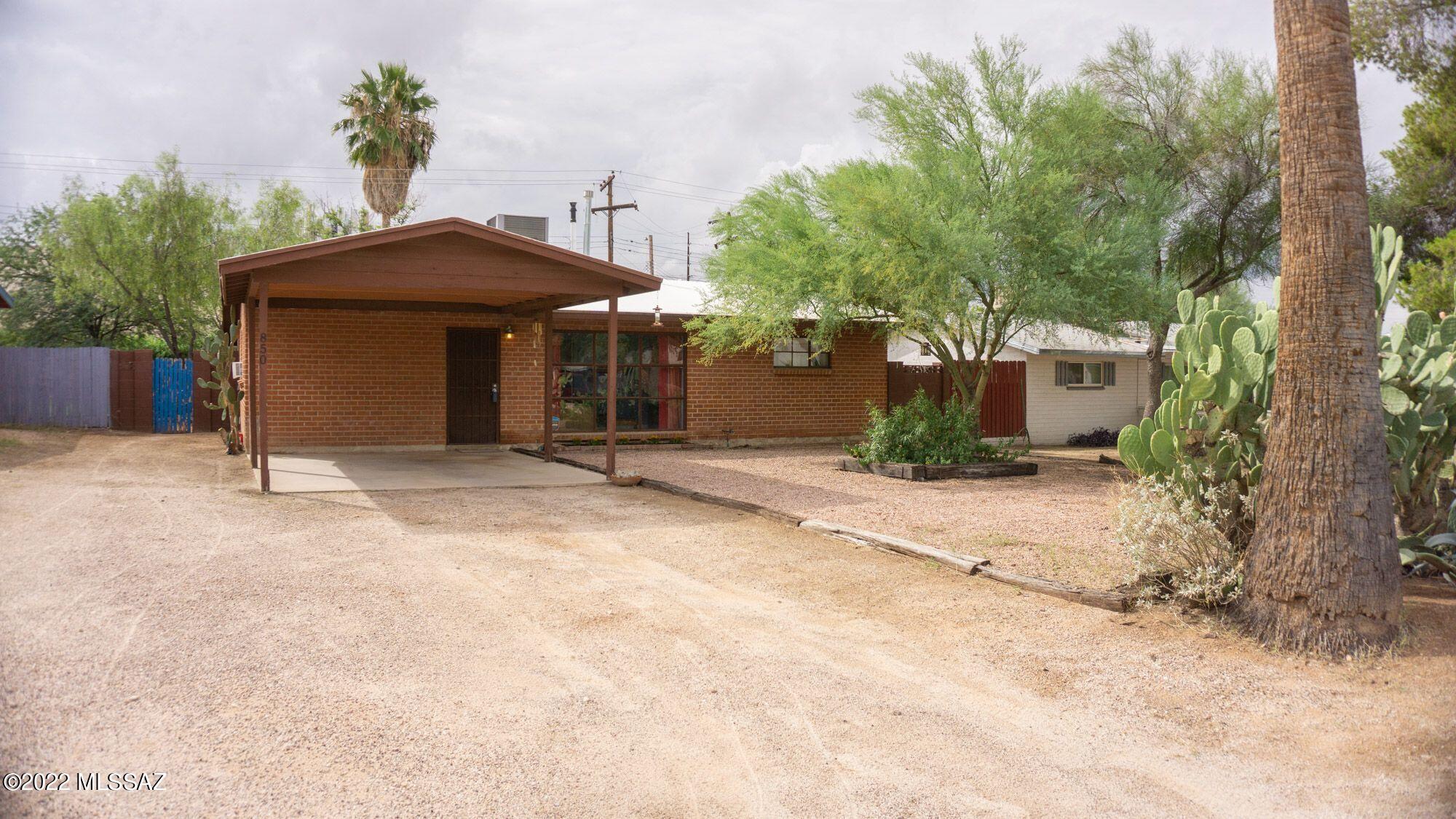 Central mid-century charmer loaded with major upgrades! Minutes to UA, Banner-UMC, downtown. Since 2018, new electric with 200amp service, new A/C-Heat (Carrier gas pack), new plumbing  - including sewer line to street, roof recently recoated, new tankless water heater.
Home features split plan with large secondary bedrooms, including one en suite bedroom, prefect for teens, in-laws, renters. Master bedroom opens to a space that's perfect for an office, den or sitting room. Bonus room off the kitchen can be used as a man/woman-cave, office, or teen room. The backyard is big, shady, and private, and features a cozy nook for meals or evening relaxation - even in the rain! Job relocation forces reluctant seller to let go of this colorful, comfortable property. One visit - and you'll see why