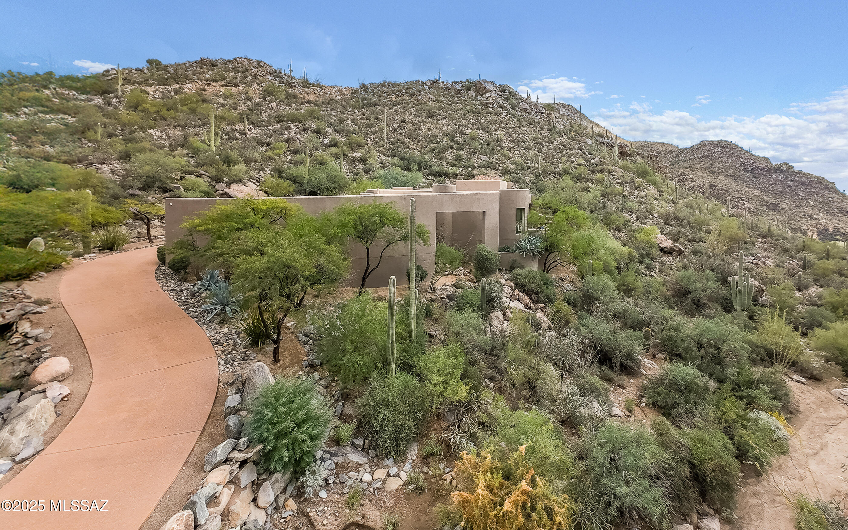 Come experience a higher level of luxury living. Welcome to this stunning Kevin Howard custom designed residence w/outstanding craftsmanship, bold style and engaging design situated on 2.5± acres within the Tortolita Mountains. You are surrounded by breathtaking mountain views. The home features elegant curvature architecture, spacious great room w/brick fireplace and floor to ceiling windows and doors. Guests will enjoy an expansive patio for large entertaining events.  The chef's kitchen includes a massive island, alder cabinets, buffet, walk-in pantry, & dining nook w/mesmerizing views. Very spacious office can double as a private 4th bedroom en-suite. A tranquil & relaxing primary suite boasts travertine floors, walk-in shower, lengthy dual sinks & access to private spa & great views! Dove Mountain is a 2025 Readers' Choice contender for Best Master-Planned Community. Enjoy Dove Mountain's world class golfing, outstanding hiking trails, biking paths, state of the art sports club, casual and fine dining options. Easy access to theatre and the arts, University of Arizona campus and multiple airports. Sonoran Desert living at Dove Mountain means enjoying outdoor living at its best.  Nearly 1/3rd of Dove Mountain's 6,200 acres of desert splendor is being kept in perpetuity as natural open space.  More than 10 miles of its boundary borders other formal preserves or Arizona State Trust-owned mountain land. That lovely "cooing" sound you hear in the evenings may be the gentle Inca Doves which live in the area and give this elegant enclave its name. Pima County's 3,000-acre Tortolita Mountain Park borders Dove Mountain to the north.  To the south is the 2,400-acre Tortolita Preserve, with its outstanding biking and hiking trails, designated to be permanently sustained by the City of Marana and the State of Arizona. Nestled in the beautiful Tortolita Mountain Foothills, Dove Mountain is perhaps the epitome of Southwest desert living. The temperate climate allows residents to enjoy an indoor/outdoor lifestyle virtually all year-round, not just in in the fall, winter and spring seasons for which the region is famous. The wildlife of Dove Mountain is fascinating. The Sonoran Desert is home to species like the Great Horned Owl, the Golden Eagle, the Black-chinned Hummingbird, Gambel's Quail, the Hooded Oriole and the Cactus Wren, Arizona's official bird. The lifestyle here is fascinating, mesmerizing, graceful, luxurious, peaceful and fun.Perhaps your own Dove Mountain story is just beginning at THIS lovely, fine custom home. Call for a private showing.