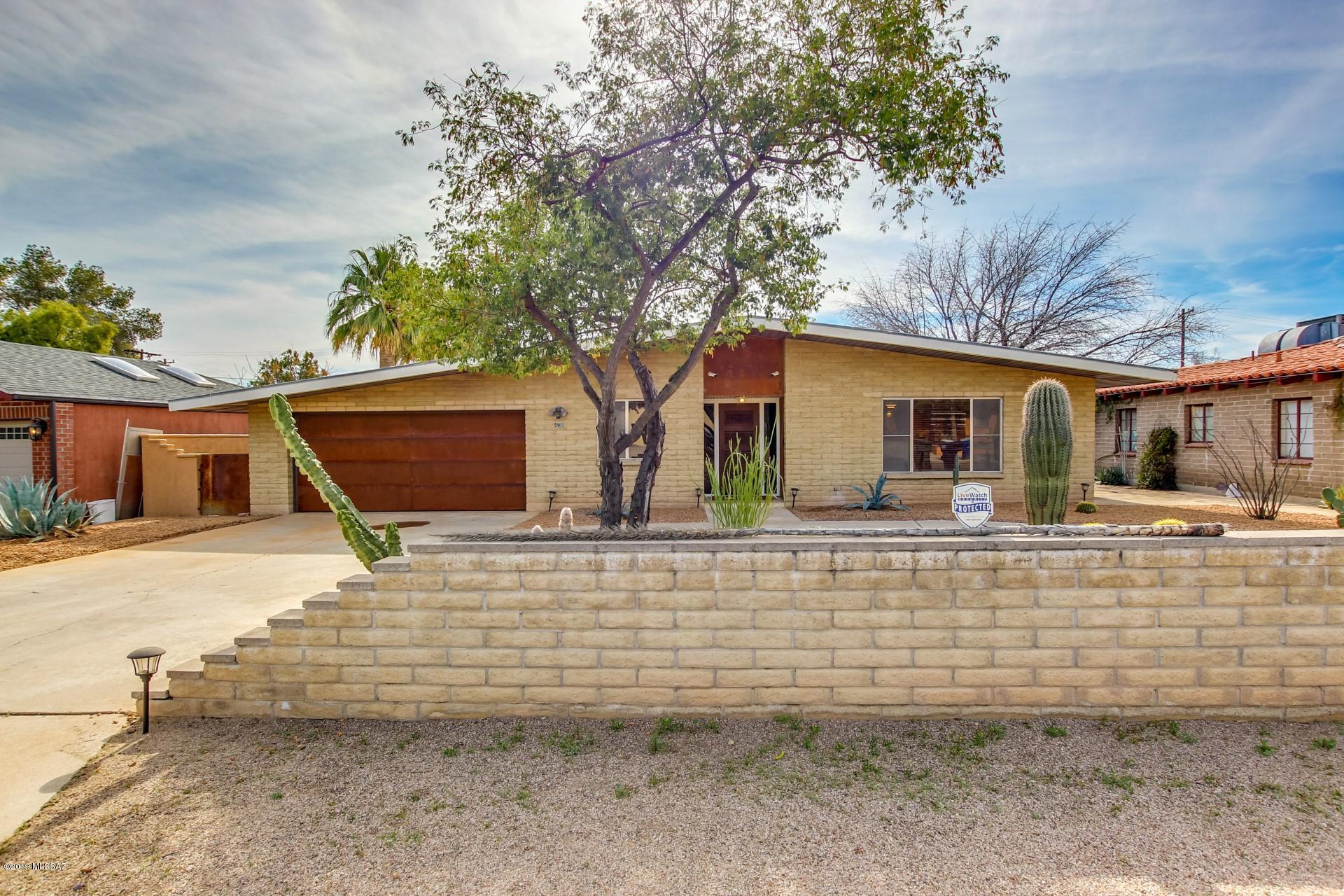 Magnificent home in wonderful Central Tucson. Situated on a large lot in ''Poets Corner'', this gem features an AZ room, beautiful elegant tile floors, 4 spacious bedrooms with modern fixtures and updates throughout. The massive great room includes an impressive wet bar, floor to ceiling stone fireplace, and ample room for entertaining your guests. The kitchen is complete with custom cabinetry, stainless steel appliances, and granite counter tops. The master ensuite has been upgraded with a massive walk-in shower, rainfall shower head, custom cabinetry and granite counters. Out back the entertaining continues with your private diving pool, and patio area perfect for hosting BBQ's.  Add this one to your must see list today!