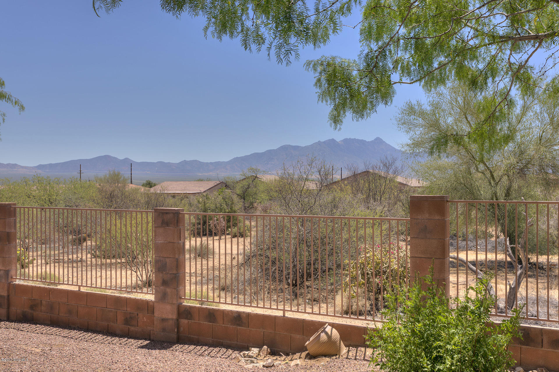 Here it is. A beautiful one owner townhome located on a highly sought after perimeter lot with great views of the Santa Ritas and the desert. This popular floor plan has split bedrooms, an interior den/office and a great room w/ soaring ceilings, large windows, a nine foot slider leading out to an extended covered patio and views beyond. The kitchen boasts tons of tall raised panel cabinetry, incredible counter space w/ breakfast bar and dome ceiling w/ ceiling fan. All appliances are included. Both bedrooms are very spacious. The master bath has a large EZ care shower, double sink vanity and walk in closet. Inside the 2 car finished garage there is a newer soft water system and storage cabinetry. Enjoy this super clean comfortable home and wonderful mountain views for years to come.  Life is good in Las Campanas Village as it is a one of a kind HOA that is set up much like a condo, but w/ fee title. They maintain your landscaping, stucco, paint and roof. Also included is the water for your landscaping; monthly pest control; expanded basic cable TV; weekly trash and recyclable pickup; fire, hazard and liability insurance; common areas, gates and road upkeep; and they also maintain a healthy reserve fund. This is the Lifestyle You Deserve.