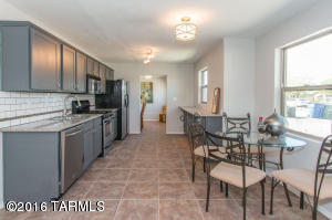 Top-to-bottom renovation in Central Tucson, with a rare fourth bedroom and two full baths. This classic Midtown home is completely modernized, with all the benefits of a convenient, Central location. Ideally located across the street from Reid Park, within walking distance of the zoo, tennis, Randolph Golf Course, Hi-Corbett Field, and more. A modern open floor plan showcases the new kitchen, outfitted with granite, custom cabinets with stainless hardware, and stainless appliances, including gas range. The kitchen includes an eat-in breakfast area, and there is also an off-kitchen formal dining room. Dual pane, energy efficient windows. Flooring throughout the house is new. New paint inside and out. Desirable north-south orientation on nearly 1/4 acre with a large enclosed backyard