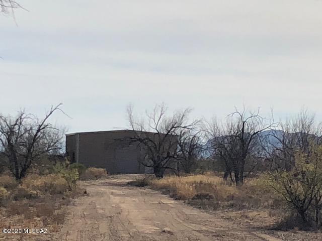 25 acres of vacant land. Road is newly graded, in front of property, 1620 sf Metal Shop, Septic Installed, Two wells - one is capped, fully fenced. Flood zone is AO, Buyer to verify property acreage.