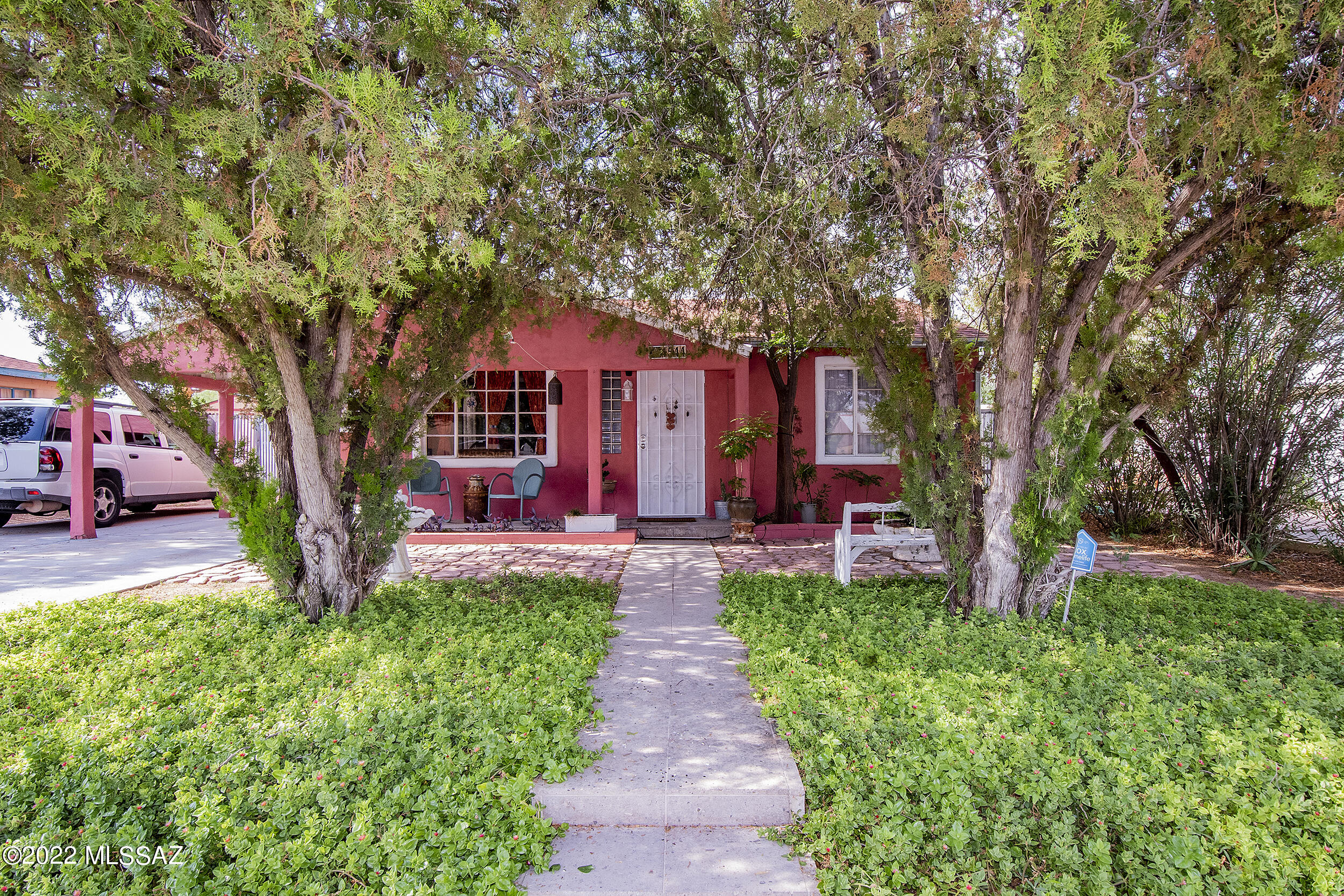 Charming, bohemian-style home in central Tucson. Three bedrooms, two bathrooms, with a split bedroom plan. Currently used, with much success as an Airbnb. The owner's suite has entry through the back, allowing two rentable spaces: The front (two bed one bath) and the back (owner's suite with space available for a kitchenette). Both front and back yards are wonderfully cared for, with mature trees and shrubs providing ample privacy. This  flexible floor plan allows the property's use as a home, short-term rental, or both. 
The original owner built the adobe walls in the backyard using mud from the property, south wall has since been redone using the same mud.
Located in the heart of Tucson, close to many stores, restaurants, shopping malls and parks.