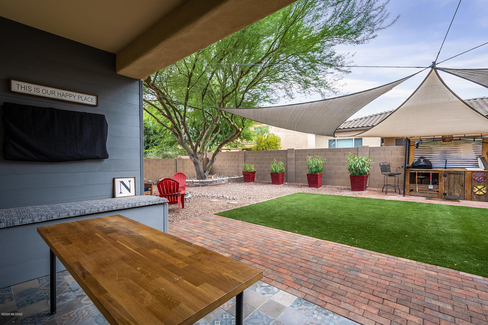 Magnificent one story home in the Master Planned Community of Rancho Sahuarita.  The home is located feet away from trail-head and park.  Stunning kitchen opens to great room and stunning back yard!!  Split floor-plan, 3 bedrooms, 2 bath, bonus room and 3 car-garage.  Back-yard is a delight for all with mounted TV, tiled flooring, turf grass, plenty of shade and BBQ.  Don't miss this GEM!!