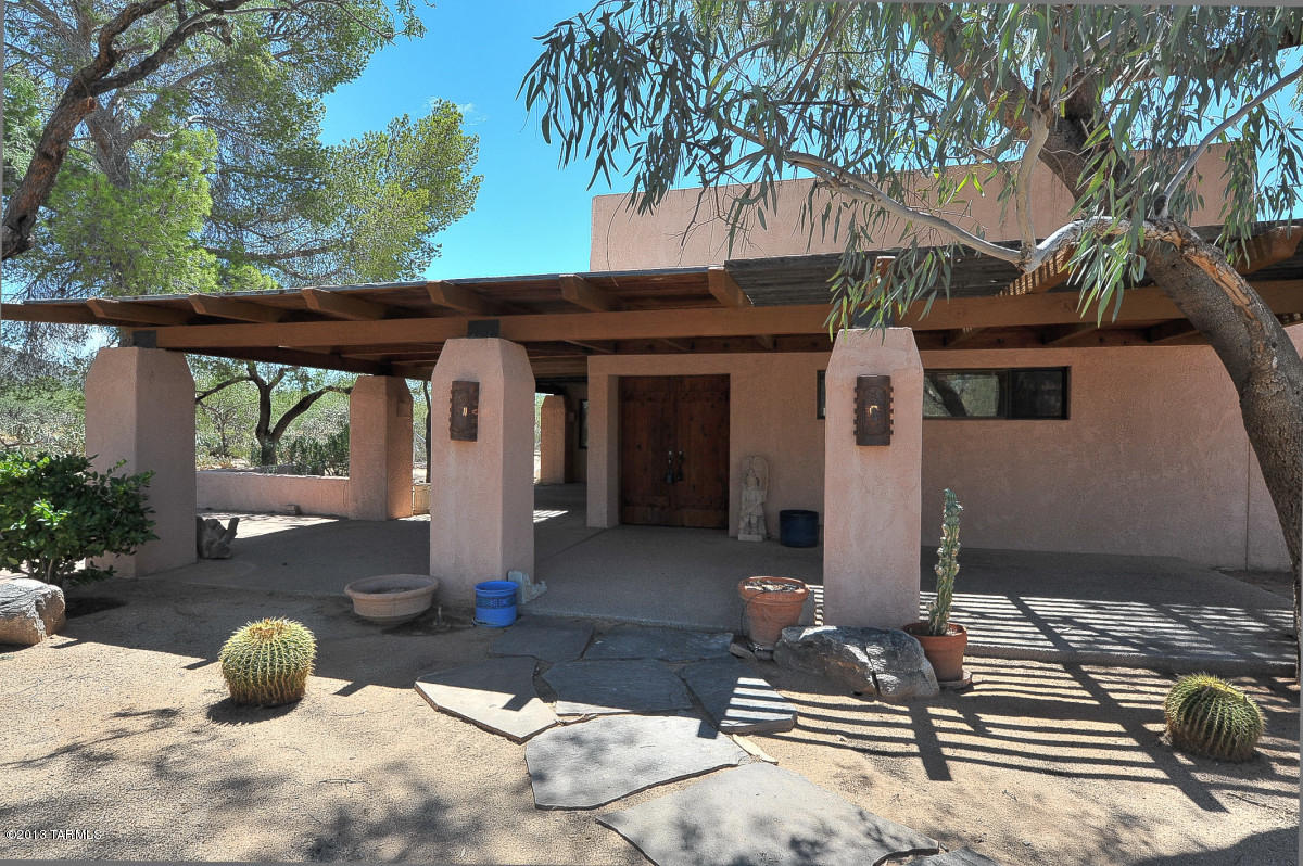 3 Acre Hidden Gem is a must see!  Santa Fe style with newer carpet and appliances, Split Master plan, living room with Fireplace, AZ room, Dining Area. Stackable washer/dryer.  Enjoy the gorgeous Catalina Mountains from your covered full length front porch. Lush landscape with yard service. Separate Storage shed. Short dirt road to property.  Ask about#1700