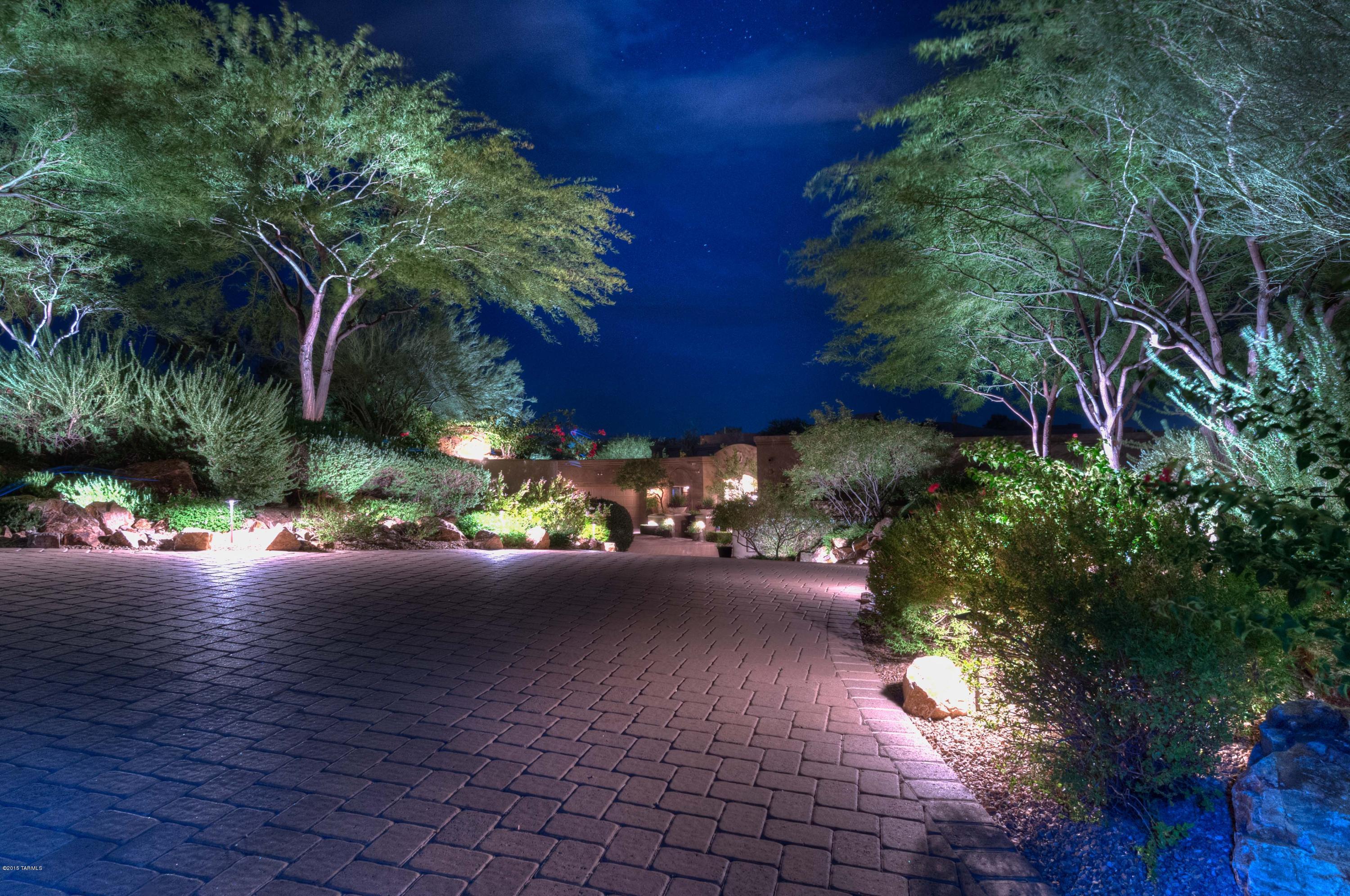 From the moment you enter the impressive gated courtyard you are welcomed to a home of unsurpassed beauty & quality. Featured in July 2015 ''Tucson Lifestyle'', this is a stunning one-of-a-kind Italian-inspired home in gated Reserve at Coyote Ridge. Exquisite attention to detail begins w/casual-yet-elegant living, dining, and family areas that open to breathtaking mountain & desert vistas. Expansive outdoor living includes a lush ''secret garden'' w/fountain & flower gardens, negative-edge pool, spa, outdoor kitchen & dining areas & an outdoor living room (1000+ sqft of cov'd patios). The beautifully-appointed interior features the finest amenities & comforts. Striking stonework, elegant columns, and coffered ceilings are only some of the details that accentuate the inviting living spaces.