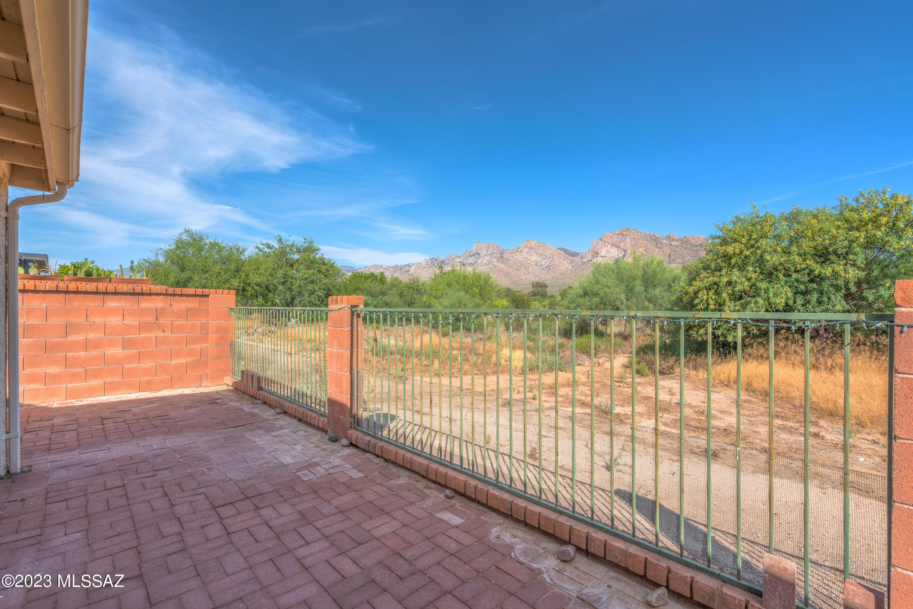 Spacious 3 bedroom, 2 full bath (2,066 sq ft) home in guard gated Villages of La Canada backs to open space and offers breathtaking Pusch Ridge views from rear of home. Enter to find soaring vaulted ceilings, plantation shutters, formal living/dining room off foyer plus Great room with chef's kitchen and patio access. Primary bedroom hosts en suite bath with dual sink vanity, walk-in shower, walk-in closet and enclosed bonus room with patio access. Laundry room with cabinets plus 3 car garage with workbench. Covered rear patio with extended brick pavers flows to side yard with hot tub. Mature trees and view fence that backs to open space with walking trail and spectacular Pusch Ridge views! Nearby golf, Riverfront Park plus shopping, dining and entertainment in the heart of Oro Valley.