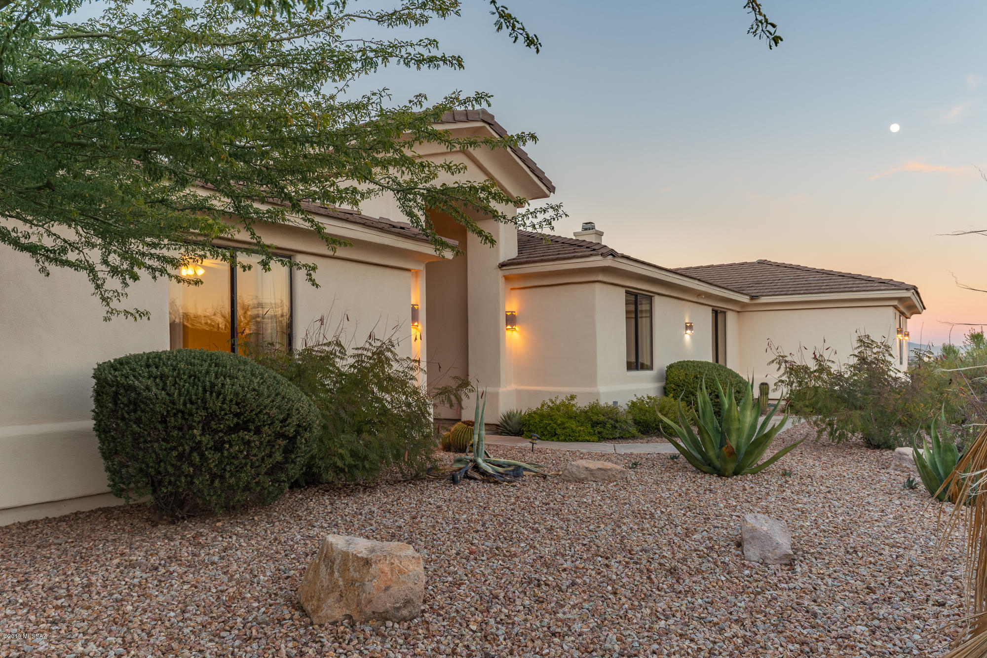 Beautiful West side Contemporary home on 1.73 acres at the foot of the Tucson Mountains.  Home Features 4 bedrooms and 3 baths, ample sized kitchen, formal dining, living room and family a room located off the kitchen with a gas fireplace.  Wet bar located in the family room.  Large master bedroom with walk in closet.  Large backyard with full covered patio with a built-in barbecue grill and a negative edge pool.  Great views of the City to the East.  Views galore!  Elevated deck in backyard to draw in the panoramic views.  Easy access to downtown, Pima and the U of A.  Three car garage and NO HOA!  A truly exceptional home.