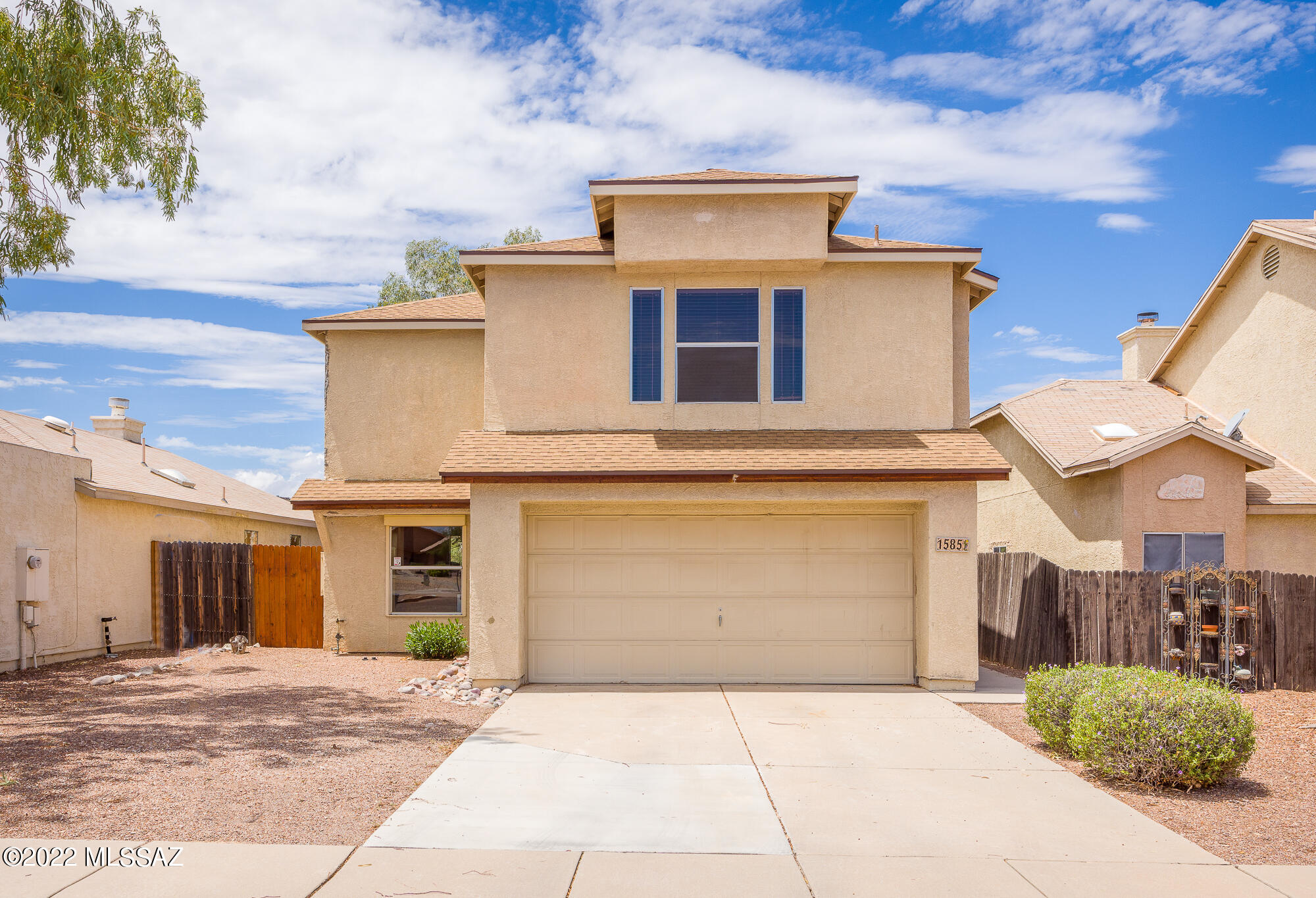 Beautiful 3BR/3BA nestled away in a dynamic West Side neighborhood. Home is situated with East/West orientation, no rear neighbors, and extremely stunning views of the Tucson Mountains off of the back. Open and airy, light and bright throughout, dining area and great room, which features a wood burning fireplace, lots of windows, and soaring ceilings up to the second floor, are located directly off of the kitchen. Master bedroom features an extremely good use of space, garden tub along with shower, and dual vanities. 2 other bedrooms and an additional full bath are located directly down the hall. A/C and water heater recently replaced, and NO POLY PIPING whatsoever. Come make this beautiful house YOUR home today.