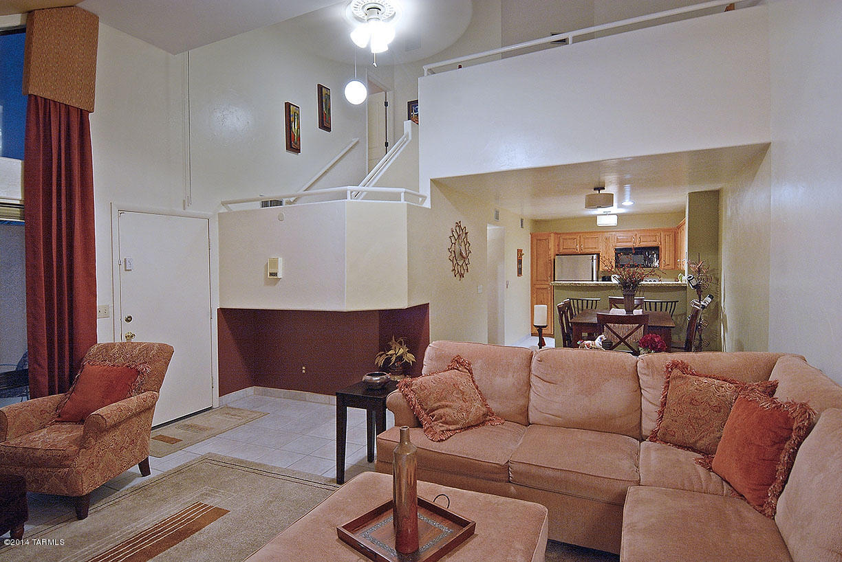 Outstanding remodeled two bedroom condo in desirable, gated Dakotah Hills with two bedrooms and loft office in the heart of the Catalina Foothills near Swan and Sunrise, La Encantada upscale shopping, fine restaurants and minutes from PGA rated golf courses and hiking trails.  With a beautiful pool and spas in the complex, this 1,467 sq. ft.  property features courtyard entry into great room with soaring two story ceiling, designer color scheme throughout, oversized ceramic tile floors, neutral carpet and custom window treatments.  Gourmet kitchen offers granite counters, stainless steel appliances, baths feature cherry wood cabinets, granite counters and brushed bronze faucets.  Views from master en suite, walk-in closets in both bedrooms, spacious loft could be office or media room. Lots of storage, luxury living at a modest price.  Being sold completely furnished with the exception of the painted ponies and Maderas tiles.