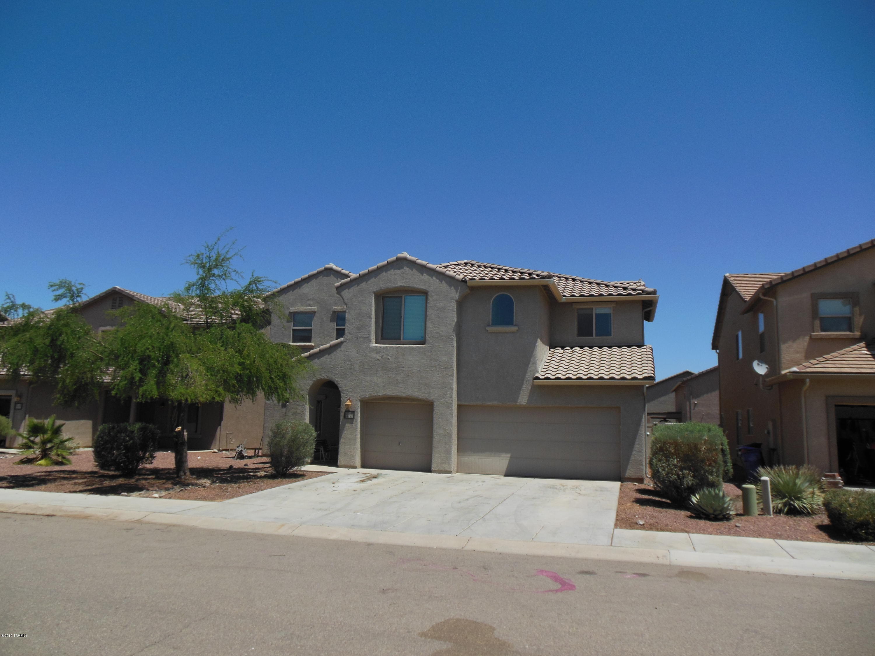 8 yr old house under $46/ft! 5 BR,4 BA.Best value in fantastic community only 15-20 min from NW Tucson. Skate park,ballfield,full basketball ct, ramadas w/picnic tables,huge pool w/slide, playground equipment.Ask about USDA loan possible w/0 down. 3 car garage. 2 master suites.Walk-in closets in all bedrooms. 16'' tile in all downstairs except bedroom. Energy-saving recirculating fan for attic. Loft looks to be wired for surround sound. Huge walk-in pantry. Abundance of kitchen cabinets w/''soft-close'' doors. Large island in kitchen. Big living room plus spacious family rm off kitchen. Covered rear porch.Big yard is blank canvas ready for your design. Stainless steel Dishwasher & Microwave stay, oven/range to be replaced w/Brand New one w/acceptable offer.Drive a little,save a lot!