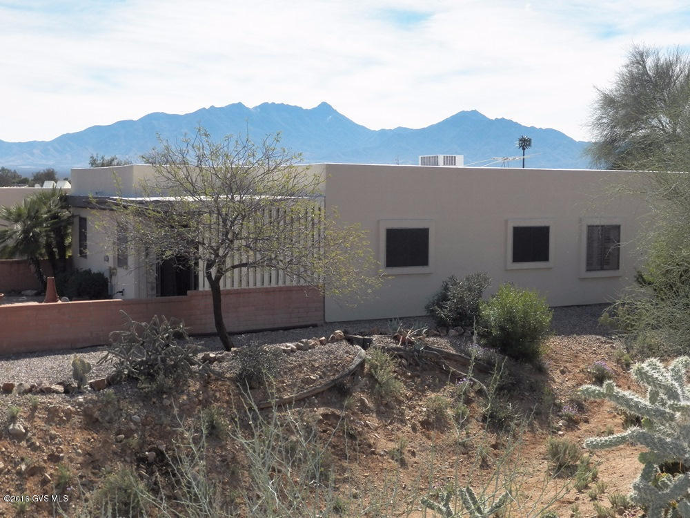 Sights, sounds and songs of the desert surround you whether relaxing on the patio or gazing out from the living area. This 2BR 2BA end unit townhome has 3 extra windows facing the desert common area. All windows have plantation shutters .The front yard offers beautiful mountain views while the completely private rear patio overlooks a huge desert arroyo. A slider opens to the spacious master bedroom suite. The especially large guest bedroom has a wallbed, built-in shelving and desk. The open kitchen, large utility room, entry and baths feature ceramic tile floors. Roof recoated Sept 2016. Abundant storage space and cabinets. A very serene desert setting yet convenient to several rec centers, shops and restaurants. Walk or bike.