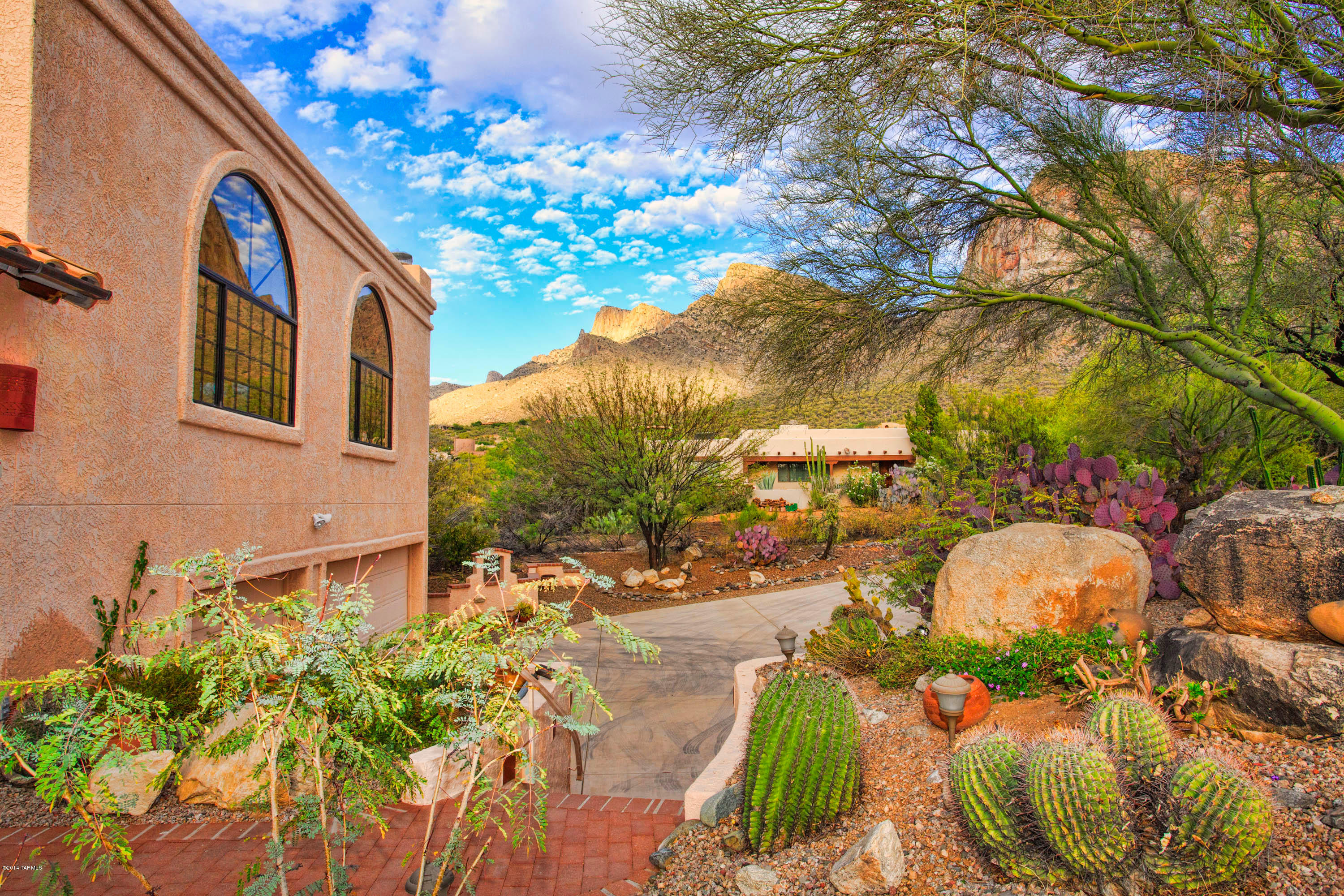 Spectacular views of Pusch Ridge & sunsets!  Spacious 4 bedroom/3.5 bathroom on 1.47 private acres in Oro Valley. New Heat Pump's and AC's installed 8/2014. Kitchen features new cabinets, slab granite counter tops and open to family room with fireplace, dining area and formal dining room. Open floor plan with high ceilings and tile floors. Living room has wood beams and wet bar. Split bedroom plan with large Master Bedroom suite, bath and walk-in closet. Laundry room with folding counter.  Brick patio with views. Screened in porch leads to a backyard private patio.  3 car extended garage with work shop area, built-ins.  Near Oro Valley Aquatic Center, Hilton Tucson El Conquistador Golf & Tennis Resort, Trader Joe's and Pusch Ridge trailhead.