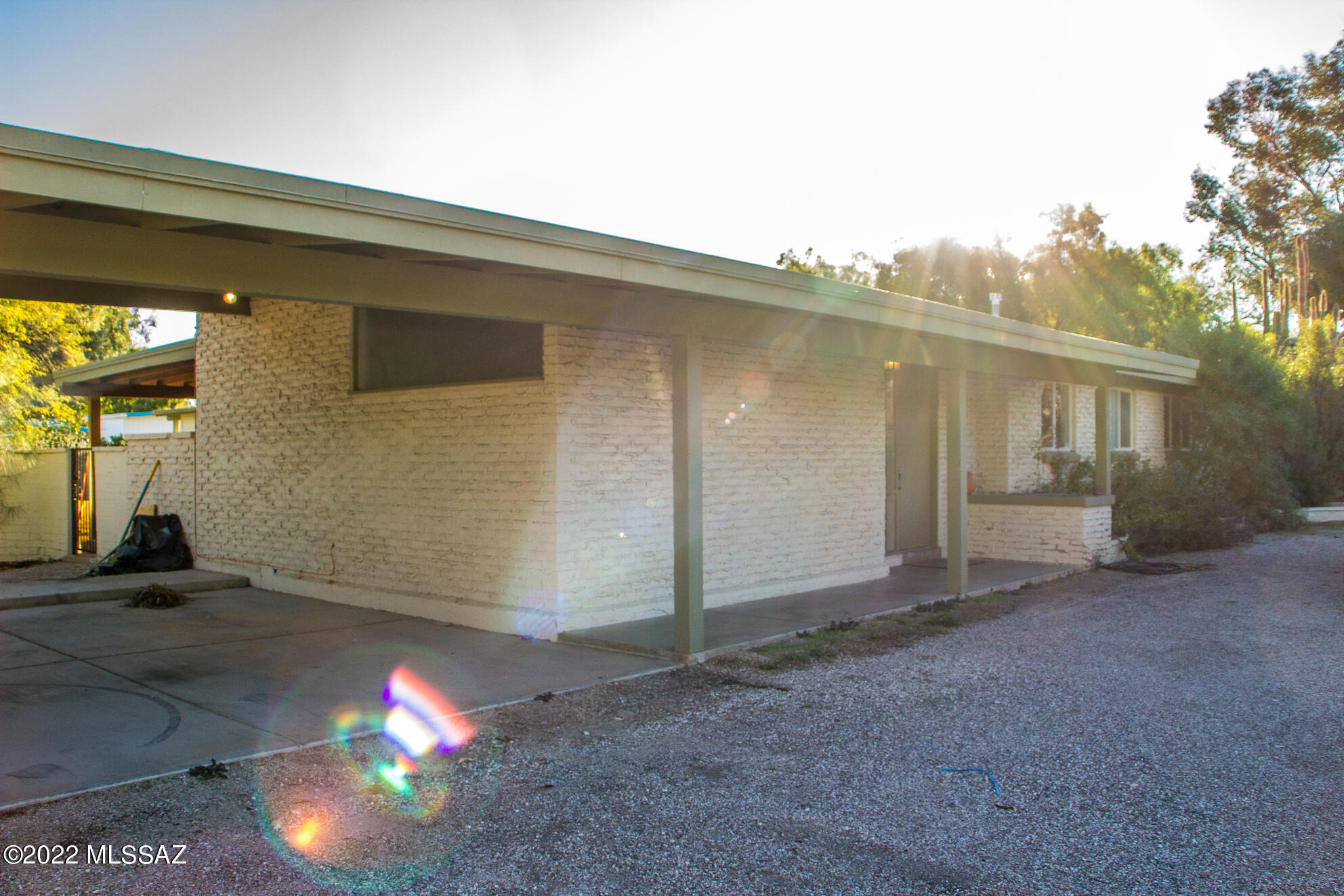 he home is set on the corner of the street with a large wrap around driveway and has a two car carport. When you enter, the living room is to your left and the kitchen to your right. The living room has lots of large open windows for great natural lighting and features a stunning fireplace and sliding glass doors to the back porch. Through the living room is the family room that is slightly bigger, has double doors for the laundry room area, and a wall of windows that looks out onto the back porch. The kitchen includes all stainless steel appliances:refrigerator, microwave, dishwasher, and stove. Through the family room down the back hall are the 3 bedrooms and 2 bathrooms.Outside is nice sized covered patio and spacious backyard.The home includes two hot water heaters, AC and is on septic