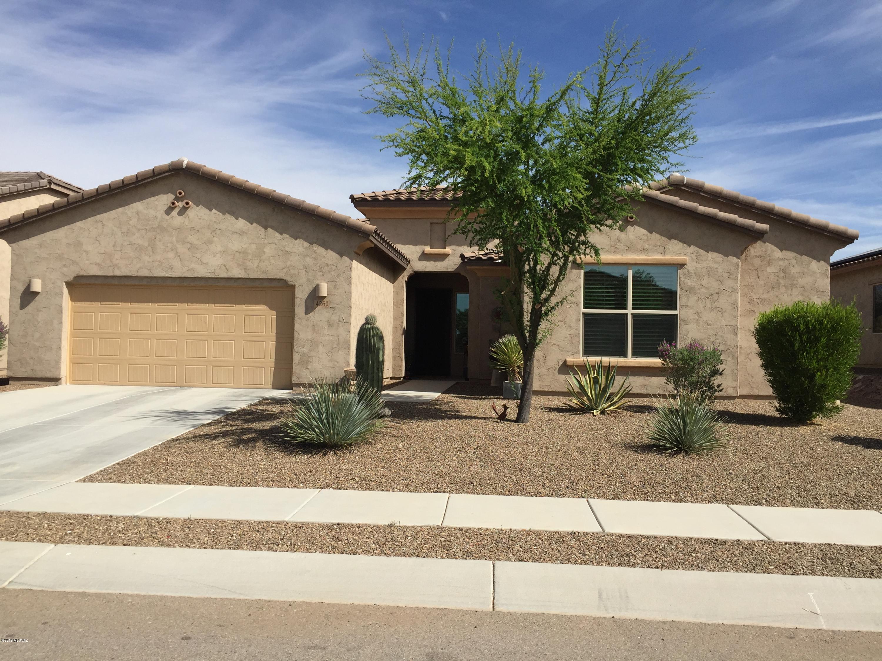 Gorgeously appointed and upgraded home in the highly sought after Skyranch community. This Webster floor plan with 10ft ceilings gives a grand feel and provides a great flow for entertaining guests or for your family's daily use. 3 br plus a den, and an office nook give you flexibility. Gourmet kitchen is upgraded with beautiful staggered cabinets and granite counter tops including a large island. Upgraded sink and faucet. The TWO large pantries and spacious laundry room have sliding barn doors. Plantation shutters throughout. Large master suite. Master bath boasts separate tub and shower and large closet with adjustable custom shelving/drawers. 3 car tandem garage also has 10ft ceiling and hanging storage shelves. The back yard has plenty of room for a pool and the view fencing and natural desert buffer make the lot feel even larger. Come see this one today and be welcomed by the tall decorative iron security door.