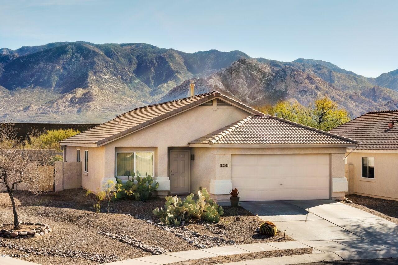 This is truly a MUST SEE home. Meticulously cared for, this 4BR/2BA is bright, open, and beautifully decorated with the finest designer finishes. The living room, dining area and family room flow into each other seamlessly, with sliding doors that open onto the gorgeous backyard graced by a pebble tech pool and breathtaking mountain views. The stunning kitchen gleams with quartz counter-tops, designer pendant lights and upgraded stainless steel appliances. Soak away your troubles gazing at the Catalinas from the garden tub in the master bath with quartz counter-top, separate shower and dual sinks. Master bedroom (with walk-in closet) and secondary bedrooms offer plenty of room for guests and/or office. Hall bath with quartz counter-tops and glass vessel sink retains the upscale styling of this outstanding home. Easy care native desert plantings in the over-sized cul-de-sac lot add to the sense of privacy and charming ambiance. The upgrades, yard, and location set this home apart from others in Rancho Vistoso. Come and see it for yourself!