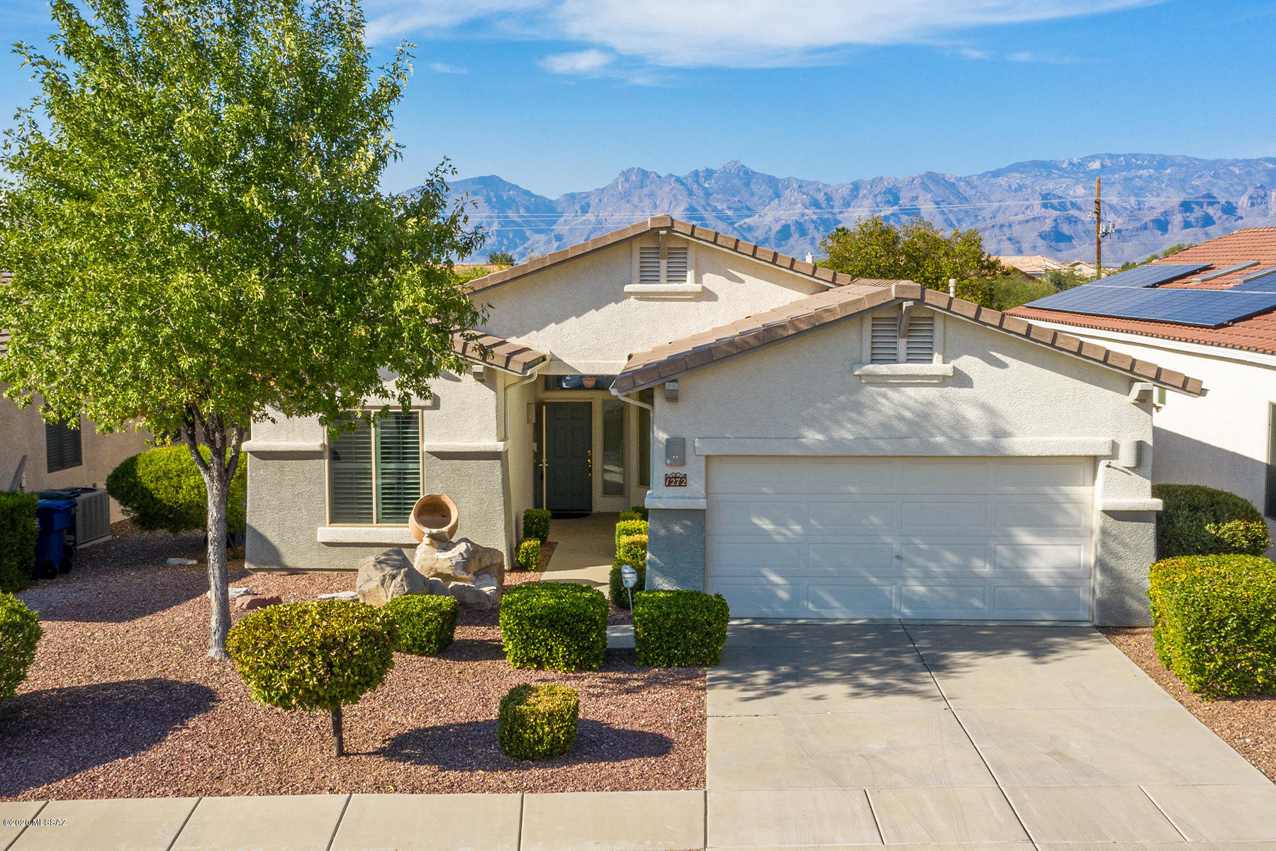 Captivating 3 BR 2 Bath home  featuring Catalina mountain views,  an open  great room, wood floors AND split floorplan!  The moment you walk in this extremely well kept property, you'll discover a  light bright home w/vaulted ceilings,  open living areas, dining area plus eat-in-kitchen nook, plantation shutters, an oversized master suite, 2 additional bedrooms & split plan! Private backyard with patios, citrus tree, & Catalina mountain views! This special house has it all, including... close proximity to multiple shopping areas, hiking (Saguaro National Park) biking loop and so much more! Bonus 3 car tandem garage with work benches and cabinet storage!! Newer microwave, oven & dishwasher! You really can have it all- a former model home  & is a one owner home! 
Best of Tucson Living!