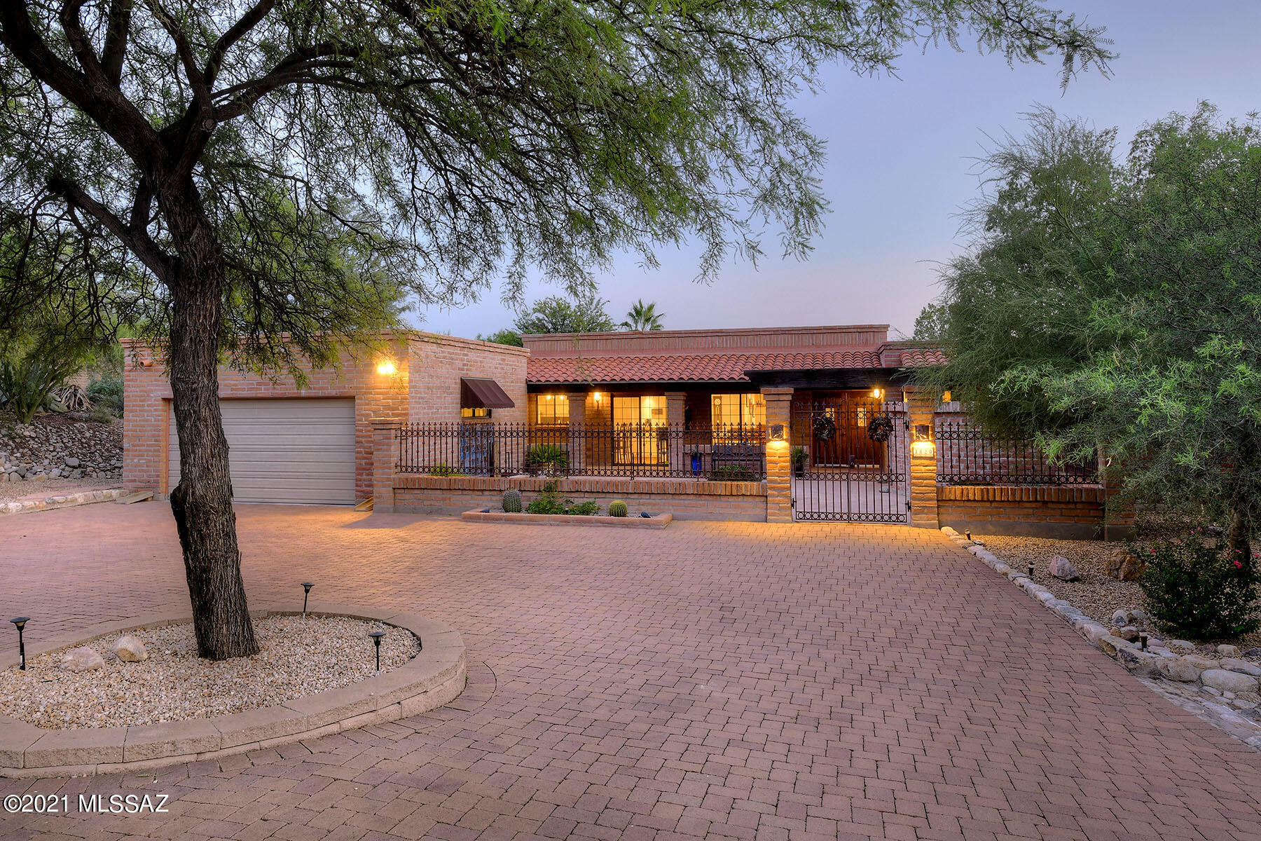Seller will accept or counter offers between $675,000 and $750,000. This stunning, remodeled & updated 2,735 sq. ft. burnt adobe territorial is located on a .89 acre-lot in the Catalina Foothills near River Road and Craycroft Road. Highlights of this 4 bedroom, 2 bath home include a circular pavered driveway, a charming courtyard with a historic wrought iron entry gate, a fountain, and a covered front patio with flagstone flooring. Interior features include a light & bright living room/dining room with a cozy beehive fireplace, a warm & charming family room with knotty pine paneled walls, a beehive fireplace & a wet bar, high ceilings, and extensive use of Saltillo tile flooring. The fabulous kitchen provides extensive granite countertops, a pantry, a breakfast bar and a breakfast area with mountain views. The gracious master suite offers access to the front and back patio and a remodeled bath with a walk-in glass shower, cherry cabinetry, limestone counters and dual walk-in closets with built-ins. The updated hall bathroom has dual vanities, cherry cabinetry and limestone counters. Enjoy the wonderful expansive back patio featuring a spacious covered porch, flagstone-style concrete overlay flooring, a burnt adobe wall, a sparkling pool with boulder accents, an outdoor kiva fireplace with banco seating, gardens, citrus trees and so much more. See to appreciate!