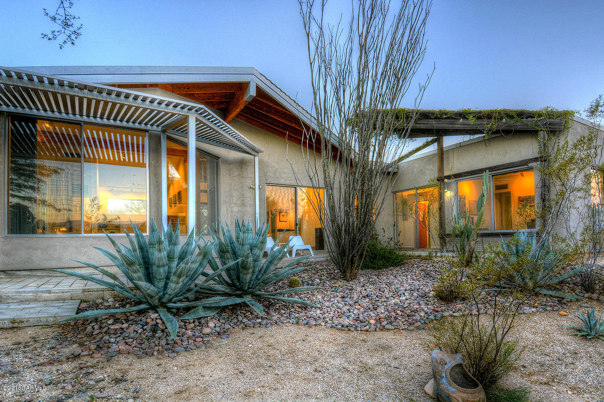 Original stunning architect's own home with beautiful views of the Catalina and Rincon mountains, on a private lushly vegetated 3.6 acres. House features dramatic high ceilings, sweeping desert vistas, loads of built-ins, polished cement floors, granite and SS kitchen, open floor plan and more. Fabulous salt water lap pool and extensive plantings enhance the exterior. Horses allowed.