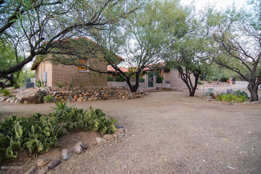 One of a kind sophisticated home. Dramatic mountain an sunset views. Enticing rich earth tone ceramic floors. Modern kitchen offers granite counters, SS appliances & gorgeous modern cabinetry. Custom rich earth tone interior paint. Rustic adobe fireplace. Large master bedroom.  Charming courtyard with mature vegetation. Professionally landscaped front and back yards. Two car garage. Come & experience the charm & warmth this home has to offer.