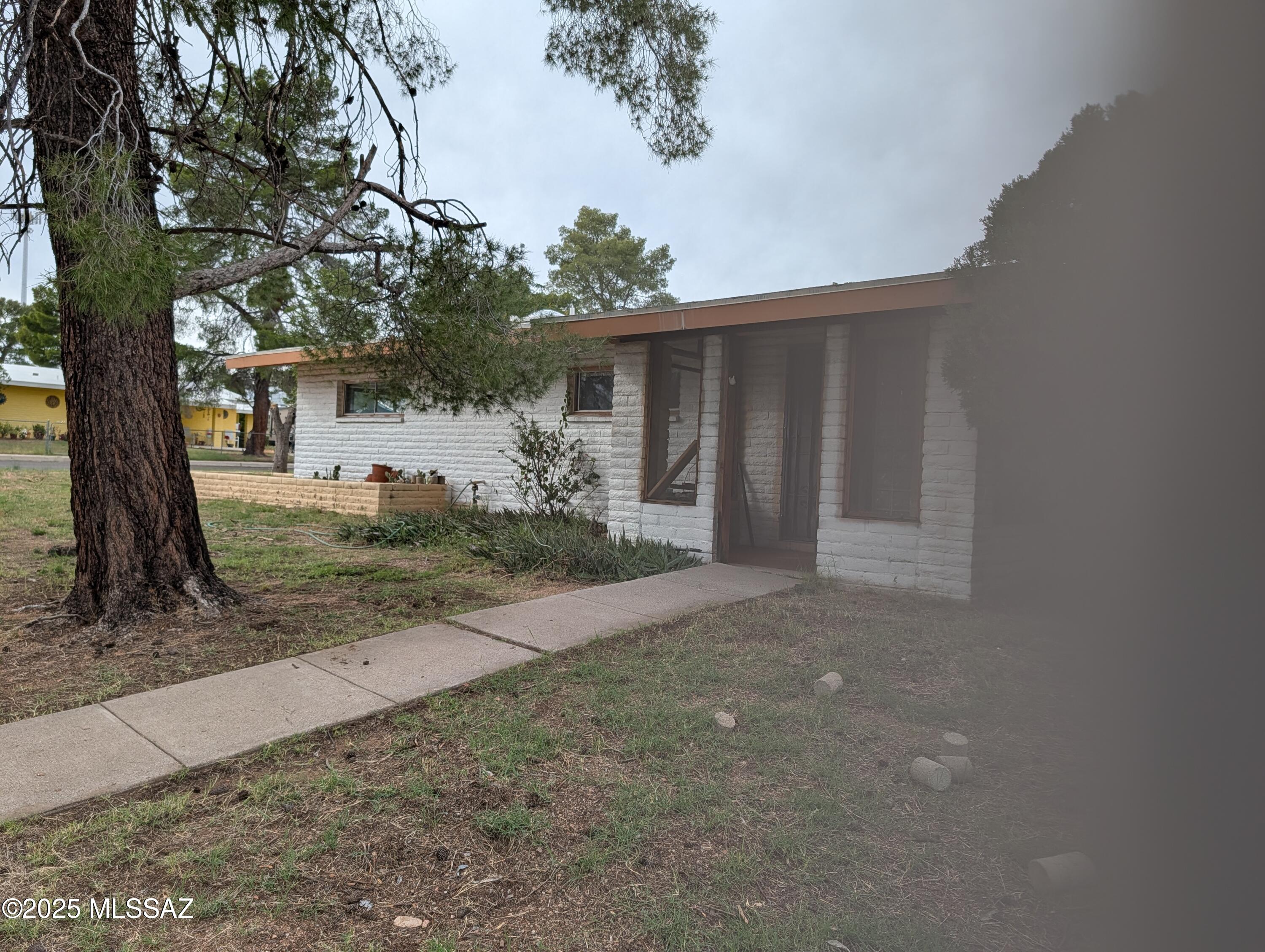 This is is located close to schools, shopping and park.  It needs some TLC, but is priced right for a home this size.  Corner lot with fend back yard. Must see!