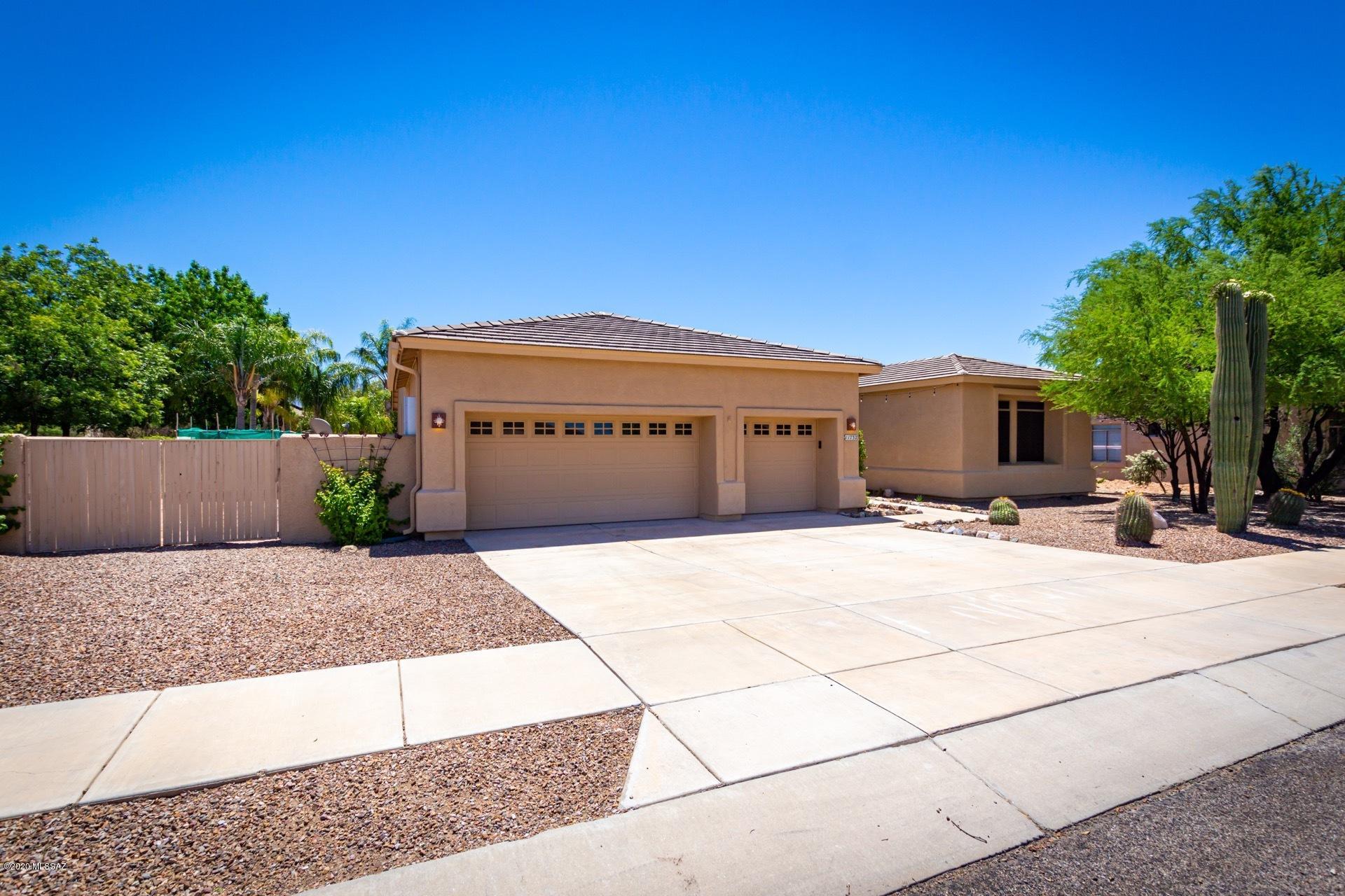 An Oasis In The Desert! This wonderful 5 bdrm 3 bath split plan is complete with a pool/spa combo, palm trees, and outdoor fire pit. Room for everyone is included in this stunning home with two living areas, a great room kitchen, jack-n-jill bath and expansive master suite. Upgraded hardwood flooring, kitchen cabinetry with custom backsplash, large raw edge granite island, bathrooms and solar energy. Large master suite is in separate wing and hosts dual vanities, garden tub, walk in shower, walk in closet and large bay windows with pool access and views. Large yard with double gates on both sides provides rear access and is perfect for entertaining guests or just relaxing by the pool. Solar Lease covers the electric usage for the entire home and pool. Fabulous find in Oro Valley!