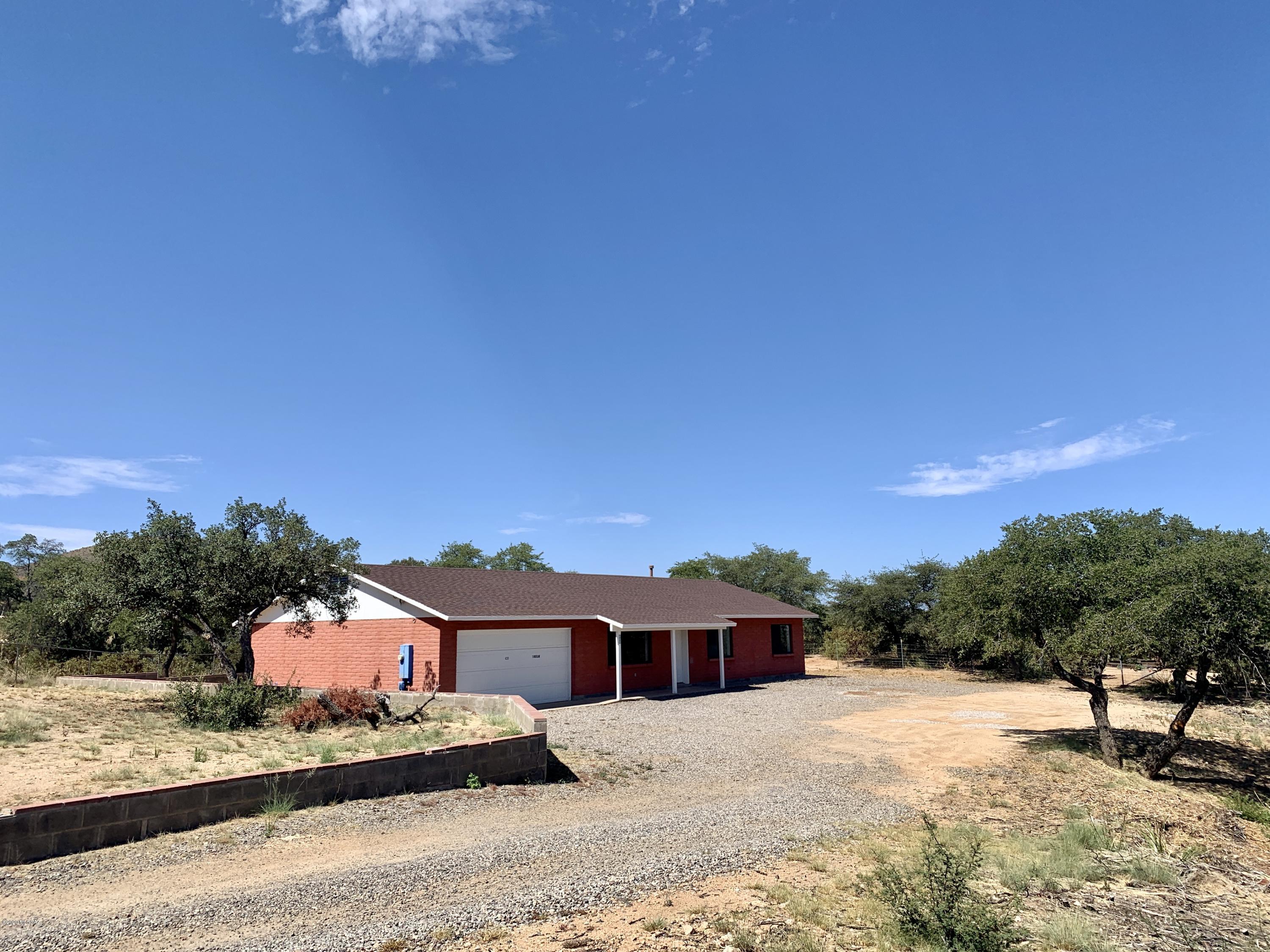 This charming 3-bed 2-bath home sits on .88 acres of boulders and mature oak trees, with lots of privacy and incredible mountain views! The interior features a two car garage, central AC, and an extended laundry room with extra storage space. The property is fenced in, with space for  parking / toys. Please text 520-490-5232 with address and your email for application and deposit info.