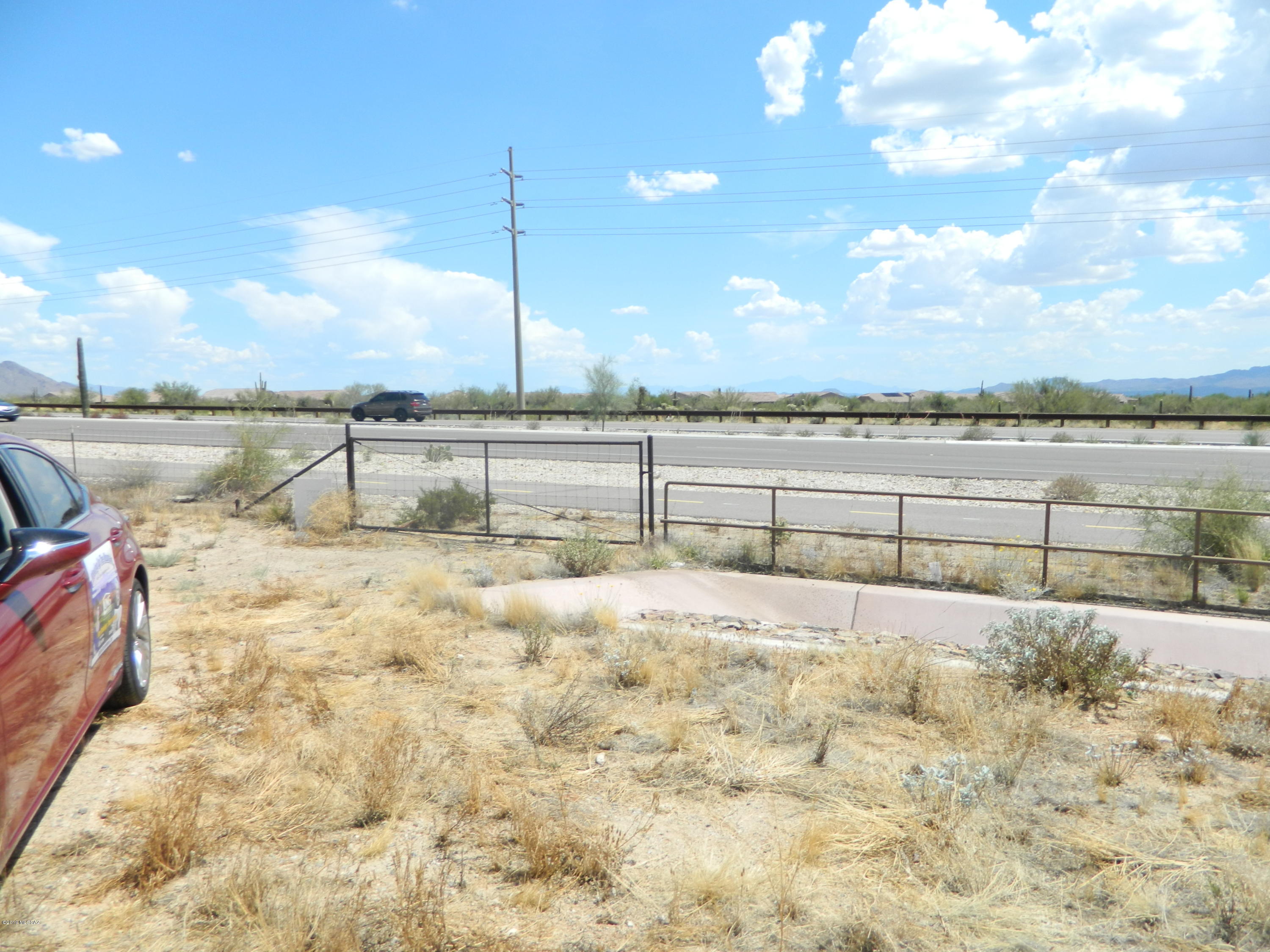 Great investment in a developing area. Very desirable build-able site with lush
vegetation and 360 mountain and sunset views. Perfect for small business or large home. Lot 8A 3.74 acres.  You can buy into the water from Tortolita Well.