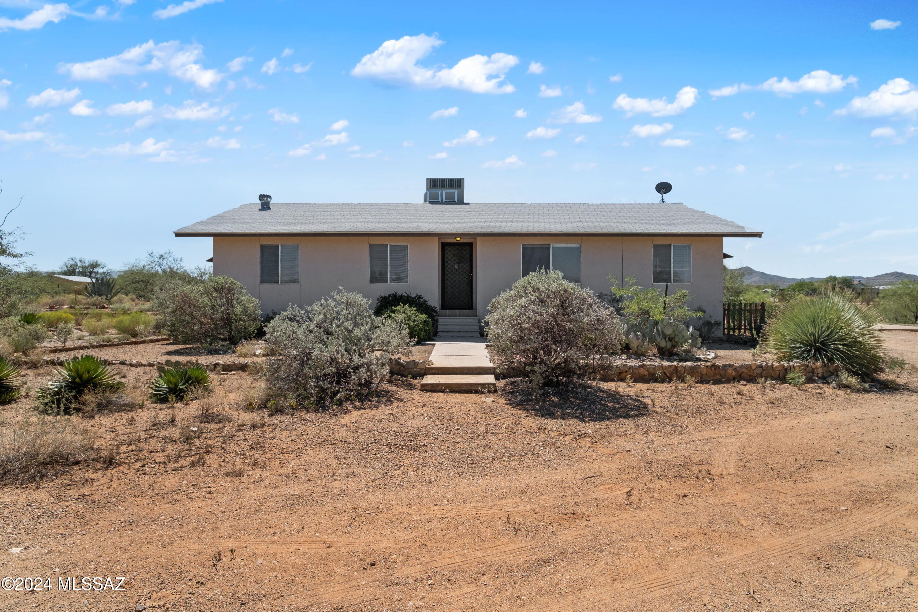 Can't miss this 4-acre horse property in the acclaimed Vail school district, just minutes from I-10! 2 1/2 acres are fenced, enclosing a cozy older site-built home with a brand NEW ROOF, a 2-stall barn, and large shop with a new roof, concrete floors, & single car garage door. The house features 3d/2ba, split floor plan, and an eat-in kitchen w/ ample counter space & mountain views. Adjacent to the kitchen is a laundry/mud room with outdoor access. The barn has electricity, auto water, a large corral, and covered hay storage.
Listing includes two Parcels for one price:
Parcel 1# is 2 1/2 fenced acres
Parcel 2# 1 1/2 acres directly adjacent to parcel #1. Large cleared area in front is perfect for a round pen, with room for a truck, horse trailer, or RV. The versatile large building can serve as a garage, storage, workshop, or game room. Adjoining acre and a half, w/ its own address and tax ID, can be sold or developed to complete your equestrian dreams.