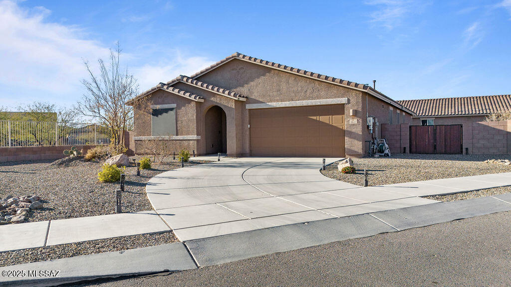 Seller is Offering $5,000 credit towards an interest rate buy-down! This stunning 2,373 sq. ft. home features 4 beds, 2 baths, and sits on a spacious ¼-acre lot in the sought-after Vail School District. Designed for both elegance and efficiency, OWNED SOLAR keeps energy costs low. The open floor plan boasts high ceilings, abundant natural light, and a gourmet chef's kitchen with granite countertops, premium appliances, and an oversized island. The expansive living and dining areas lead to a covered patio—perfect for entertaining. The luxurious primary suite offers a spa-like glass shower and dual vanities. Two additional bedrooms provide flexibility for family or guests. Enjoy a vibrant community with festive events and a playground open after hours at Esmond Station K-8!