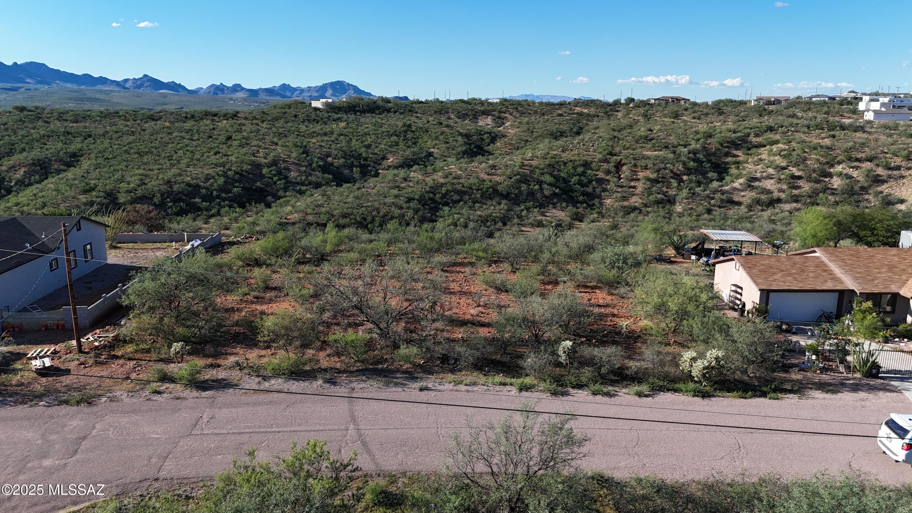 Nice residential lot, flat area close to the road then sloping in the back.  Electric and water at the street.  All paved access.  Only about 6 minutes from I-19.  Mountain views.