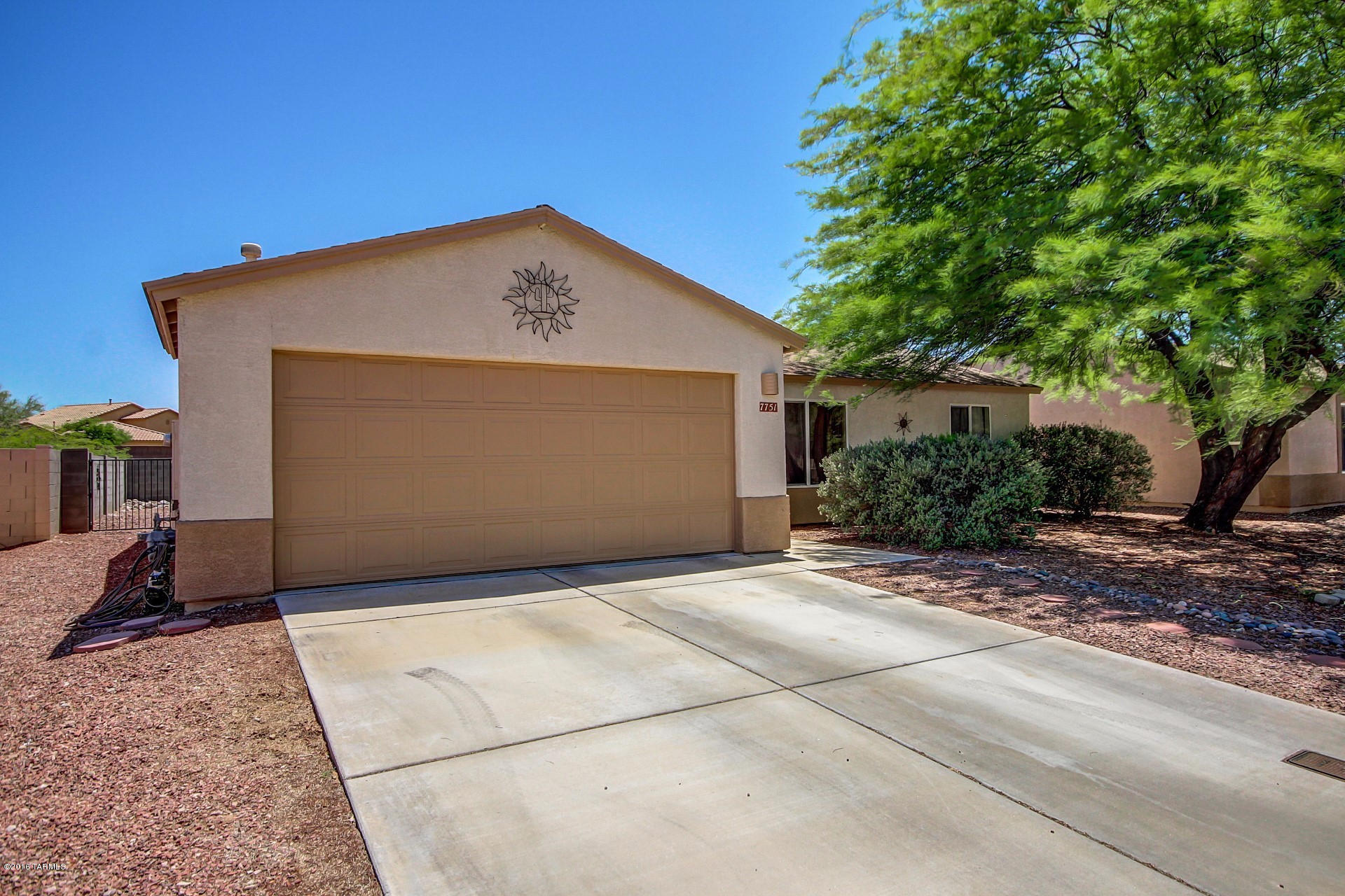 Happiness is just a doorstep away! Fall in love with this open floor plan that offers vaulted ceilings, custom paint and neutral carpeting & tile flooring throughout. Eat in kitchen boasts stainless steel appliances, honey oak cabinetry, pantry and plenty of counter space. Three spacious bedrooms! Master bedroom has an adjoining bath. Generous backyard is complete with a covered patio, grassy area and low care desert landscape. This home is the gem of the neighborhood! See it before it's discovered!
