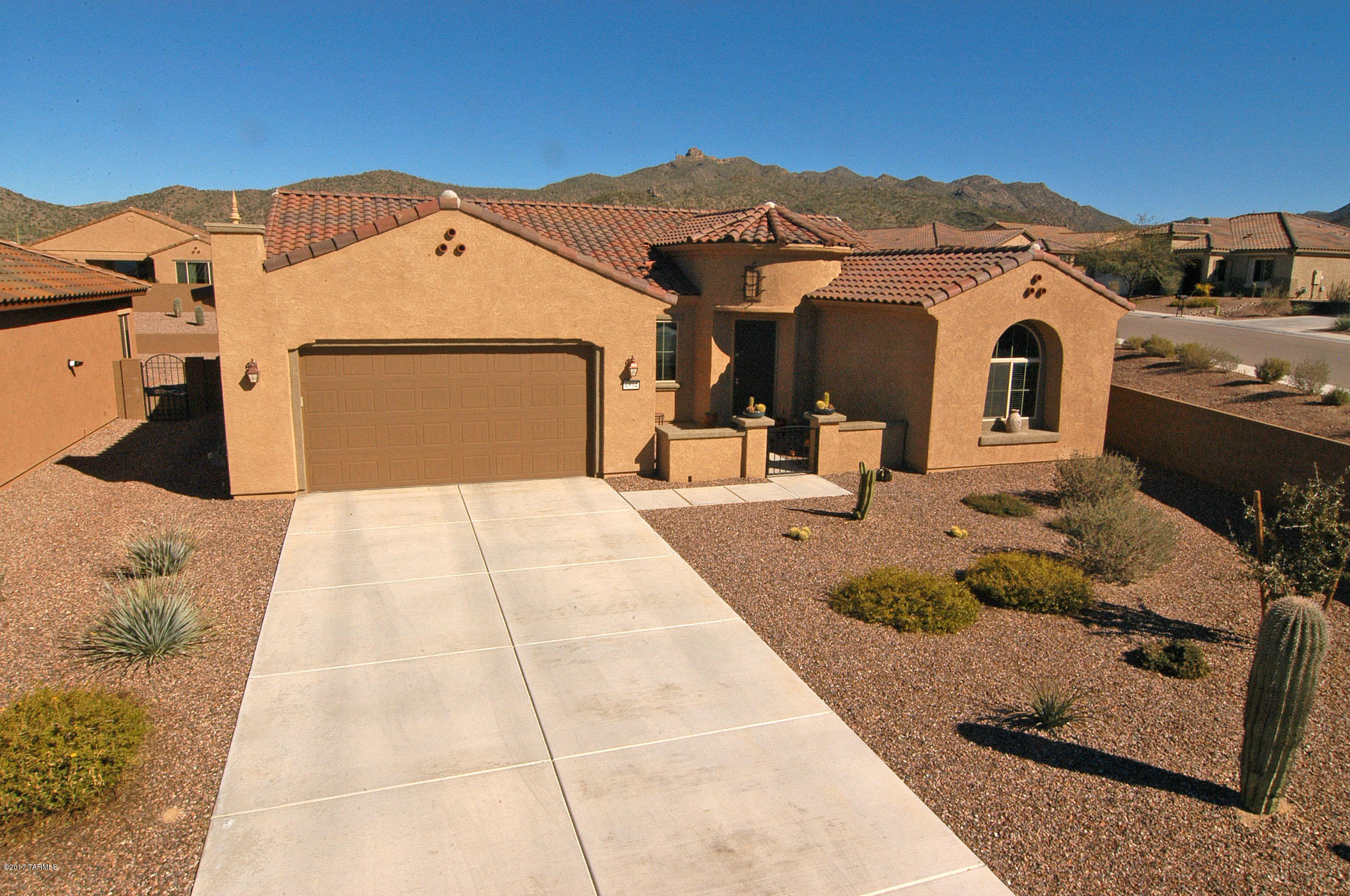 Beautifully open Serenity model with 3BR/2B plus den.  Almost brand new, plus all of the landscaping is done too.  Strategic planning for this  large .36 acre lot  is designed to provide shade & privacy as it matures.  Two irrigation systems are set up for container gardens and general watering. Still lots of room to add a pool and more.  Gourmet kitchen with upgrades galore- Butler's pantry, pull out shelves and granite counters open up to dining area w/bay windows and the inviting great room.  Ideal for entertaining.  Split bedroom plan offers privacy when guests arrive. Spacious master suite accented by bay windows.  Office, extra room, has high coffered ceilings and French doors. Extended 2 car garage  w/room for storage or  golf cart.  Come see what makes this home so special